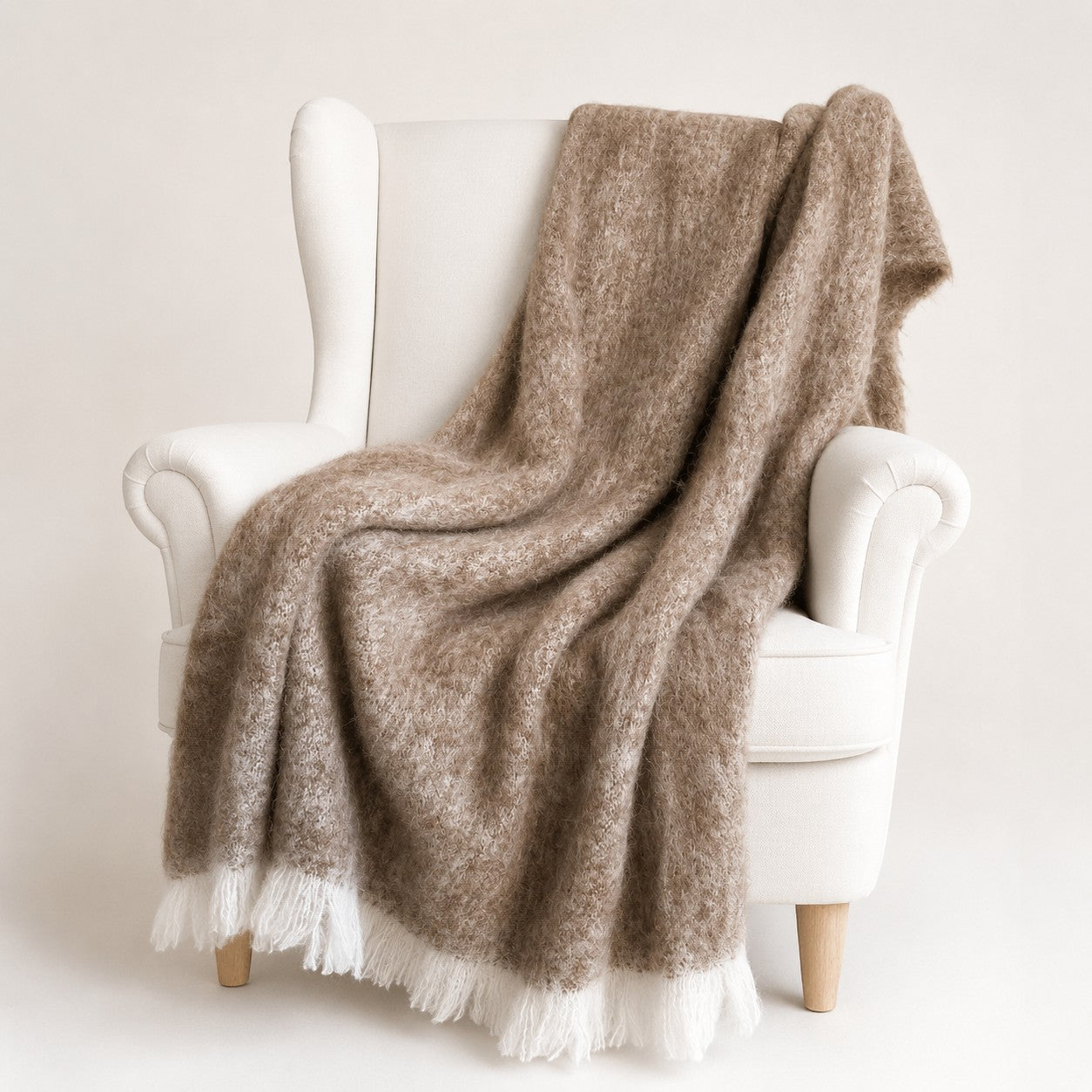 Neutral brushed alpaca throw on armchair, soft Australian alpaca home decor.