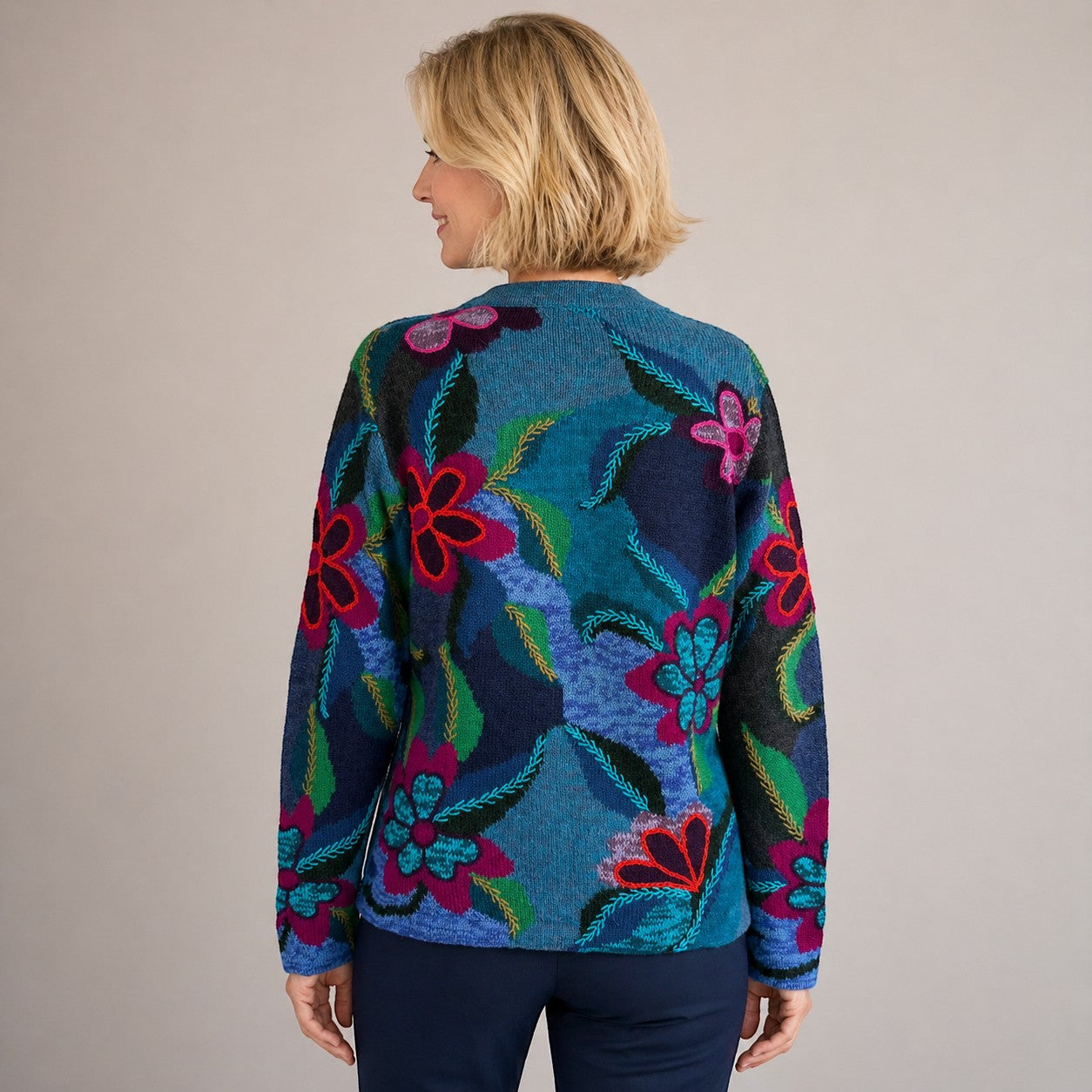 Woman wearing a colourful floral-patterned baby alpaca knit cardigan