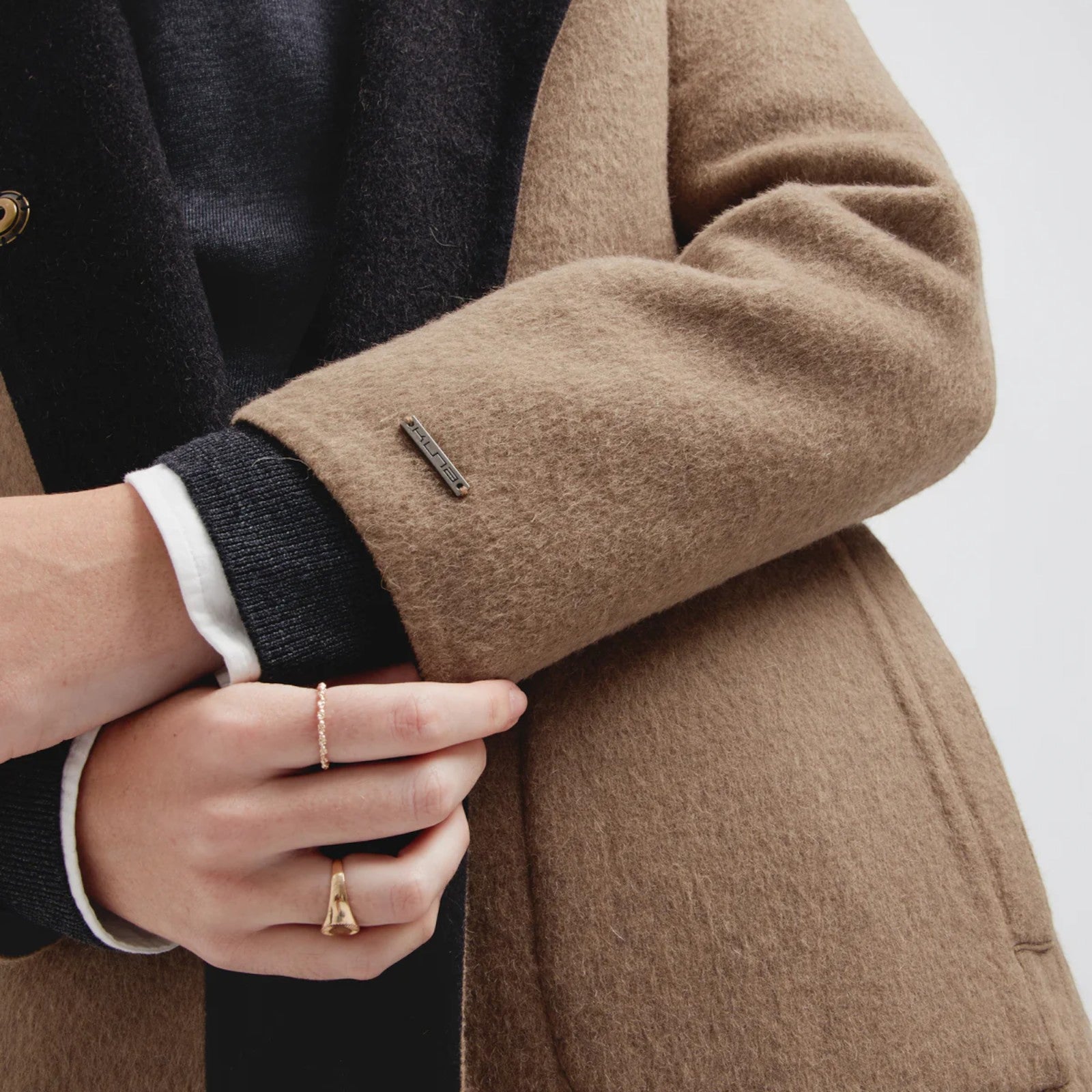 Close-up of Women’s black Caviar Baby Alpaca Coat with gold-tone buttons