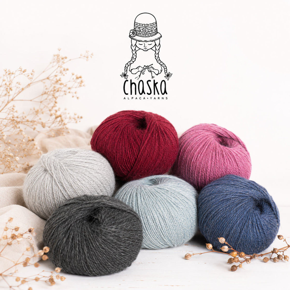 Five skeins of Alpaca yarn in red, pink, gray, blue, and black on a white background with Chaska branding.