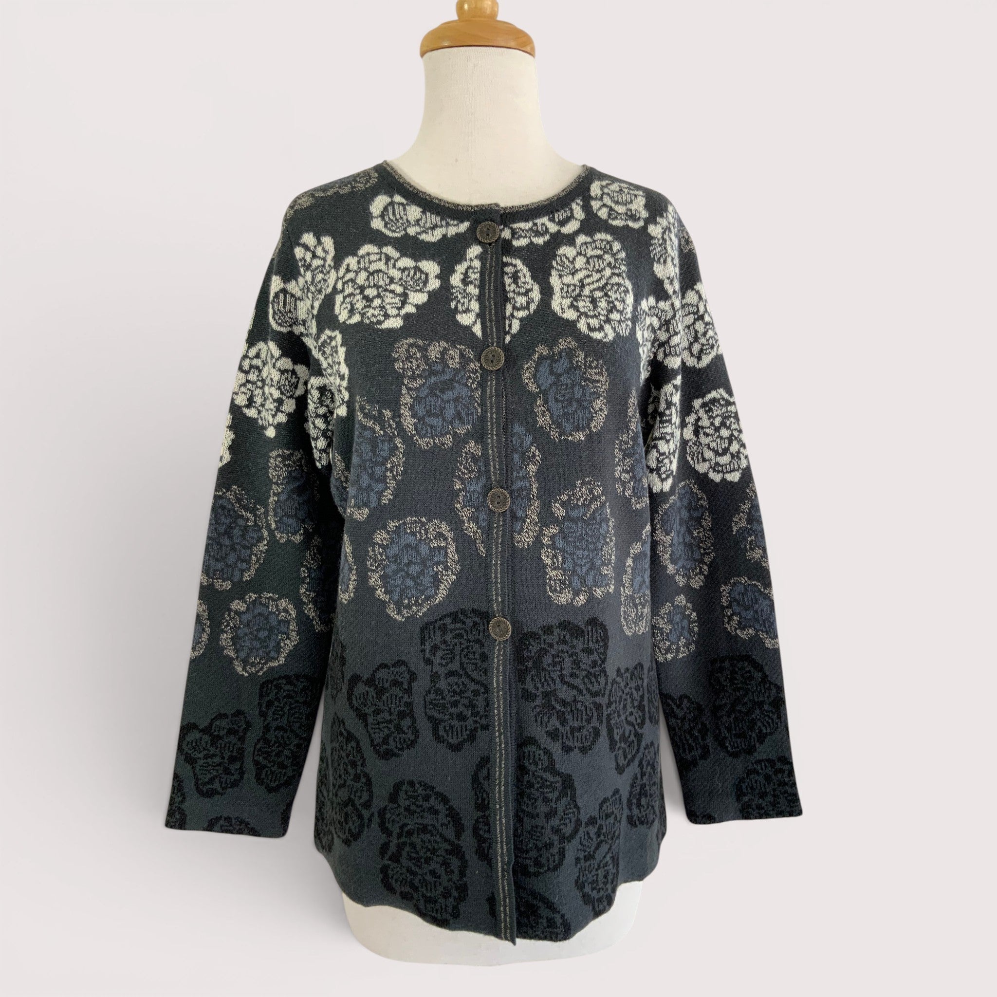 Woman wearing Chrysanthemum alpaca cardigan with floral jacquard pattern