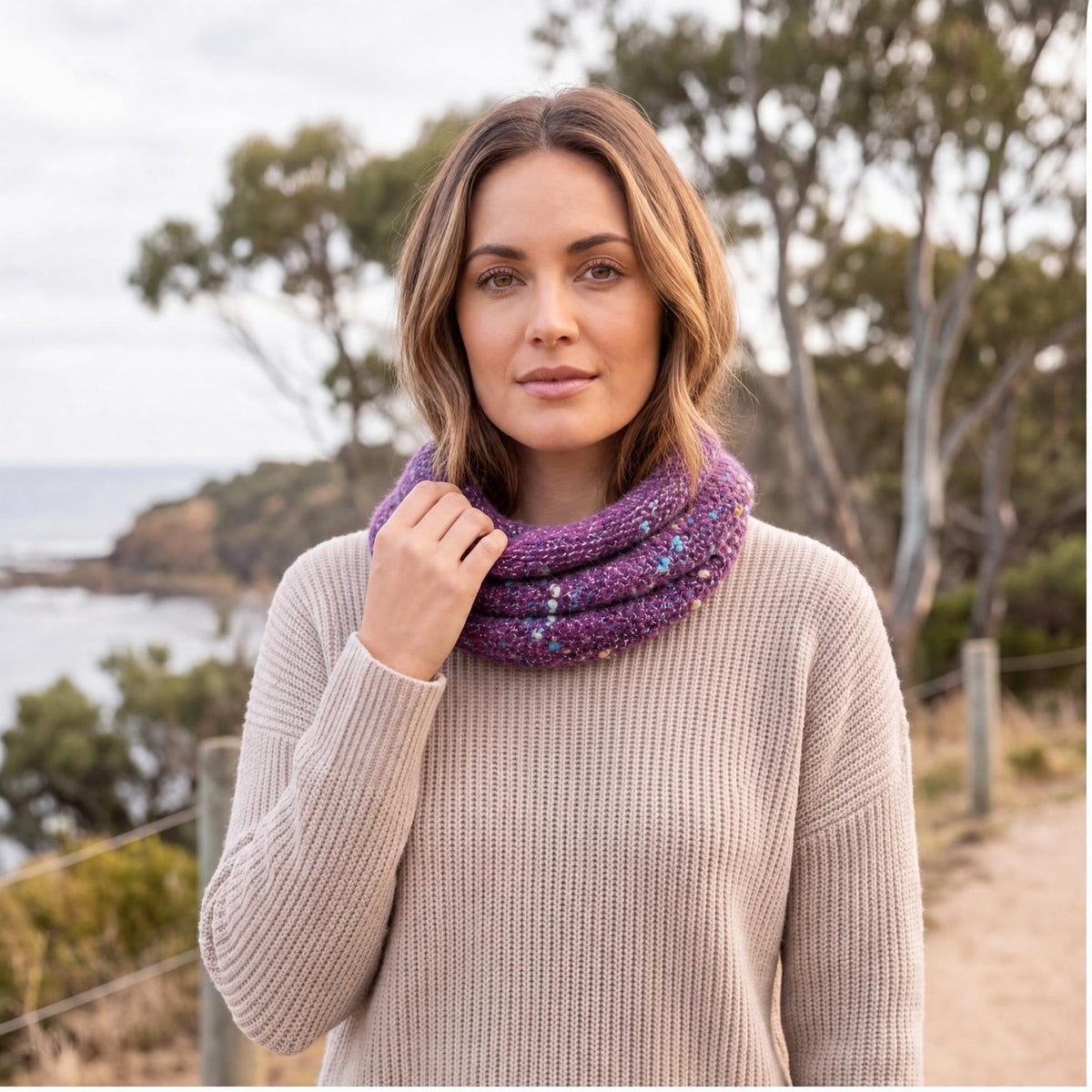 A woman wearing a Alpaca infinity scarf.