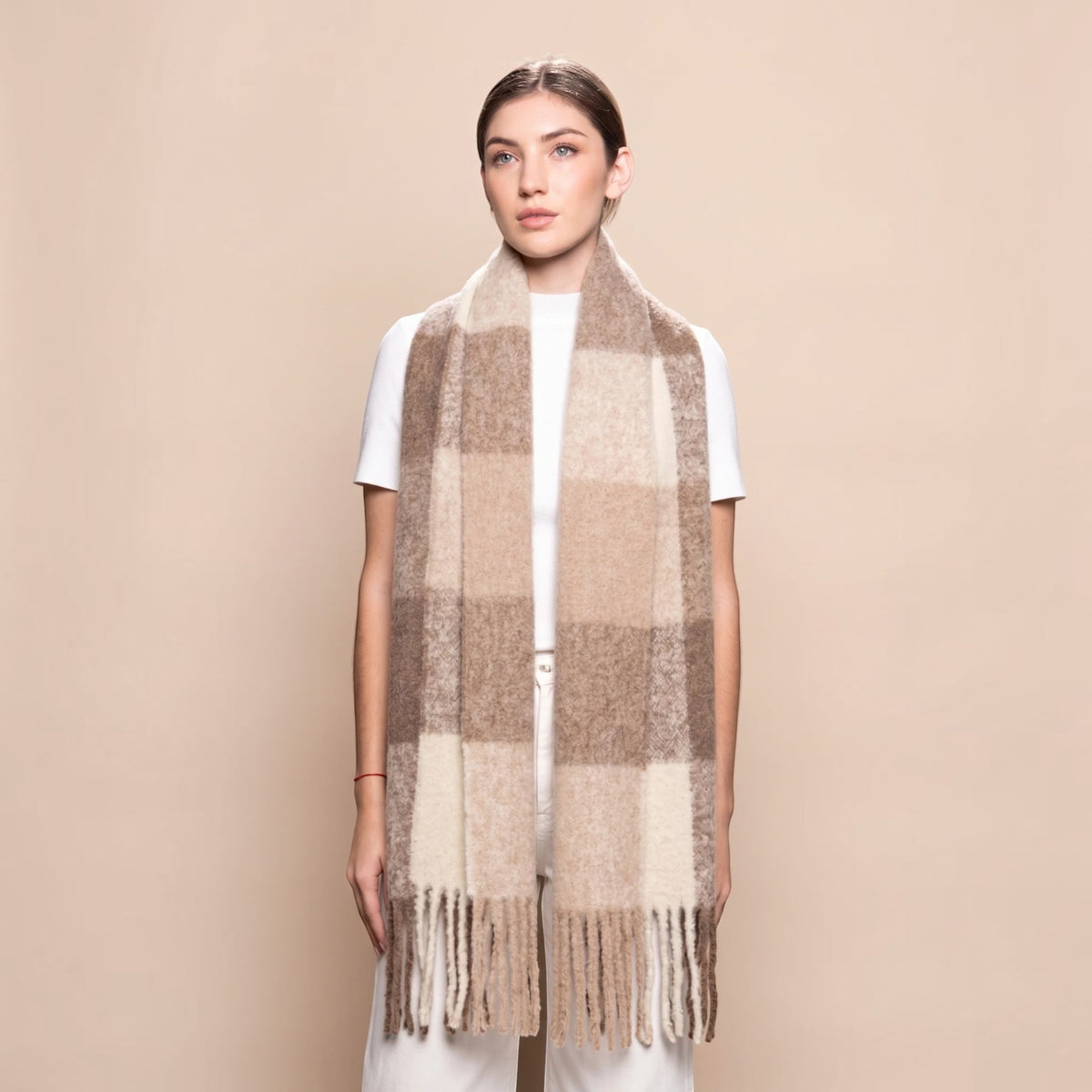 Woman wearing a chunky brown and beige alpaca blend scarf