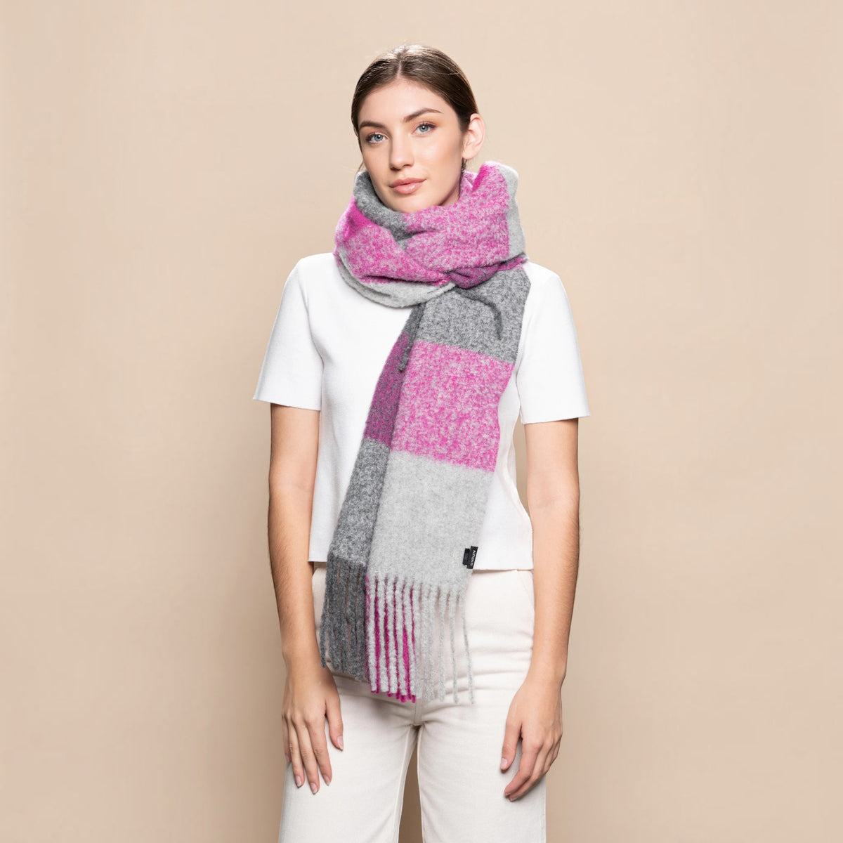 Woman wearing a chunky fuchsia and grey alpaca blend scarf