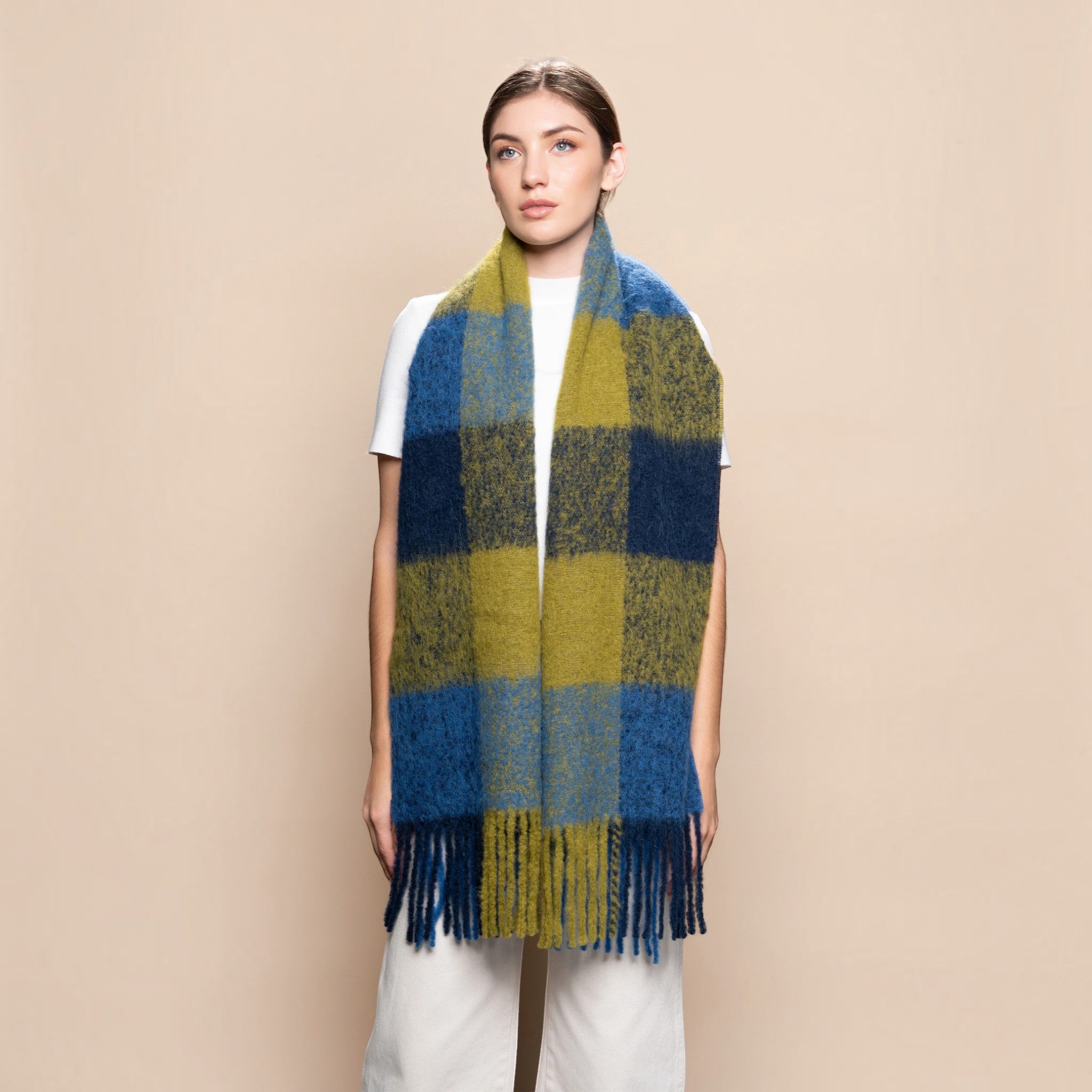 Woman wearing a chunky navy, blue and green alpaca blend scarf