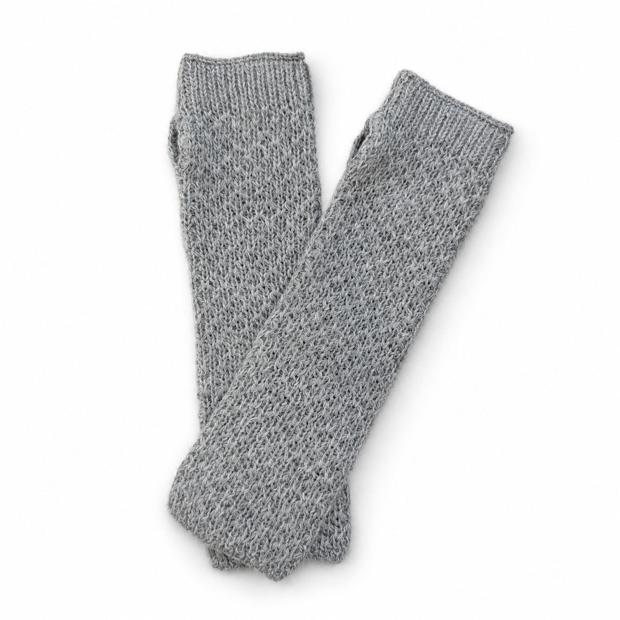 Pair of gray knitted alpaca hand warmers or gloves on a white background
