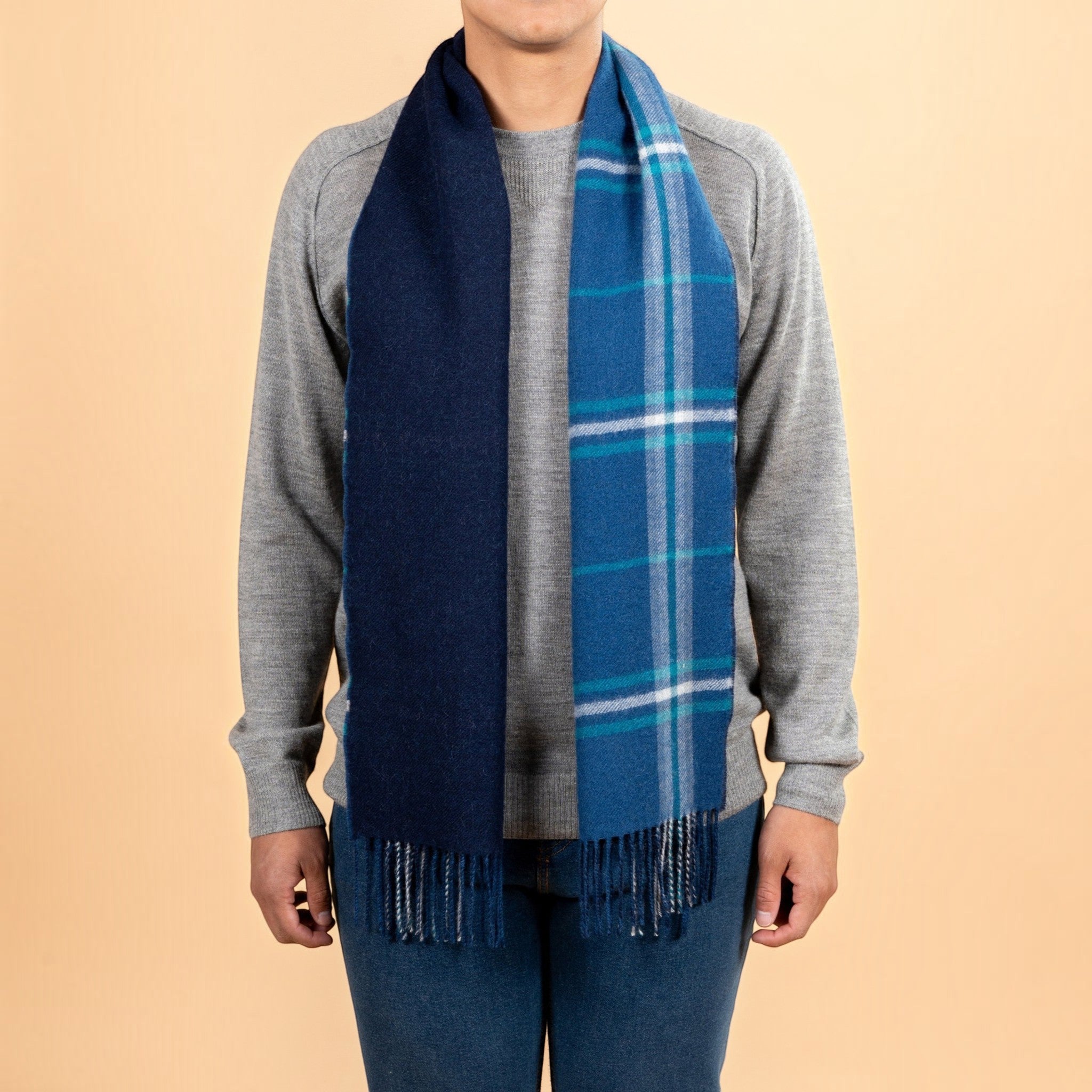 Reversible blue and navy Baby Alpaca plaid scarf showing solid and checked sides