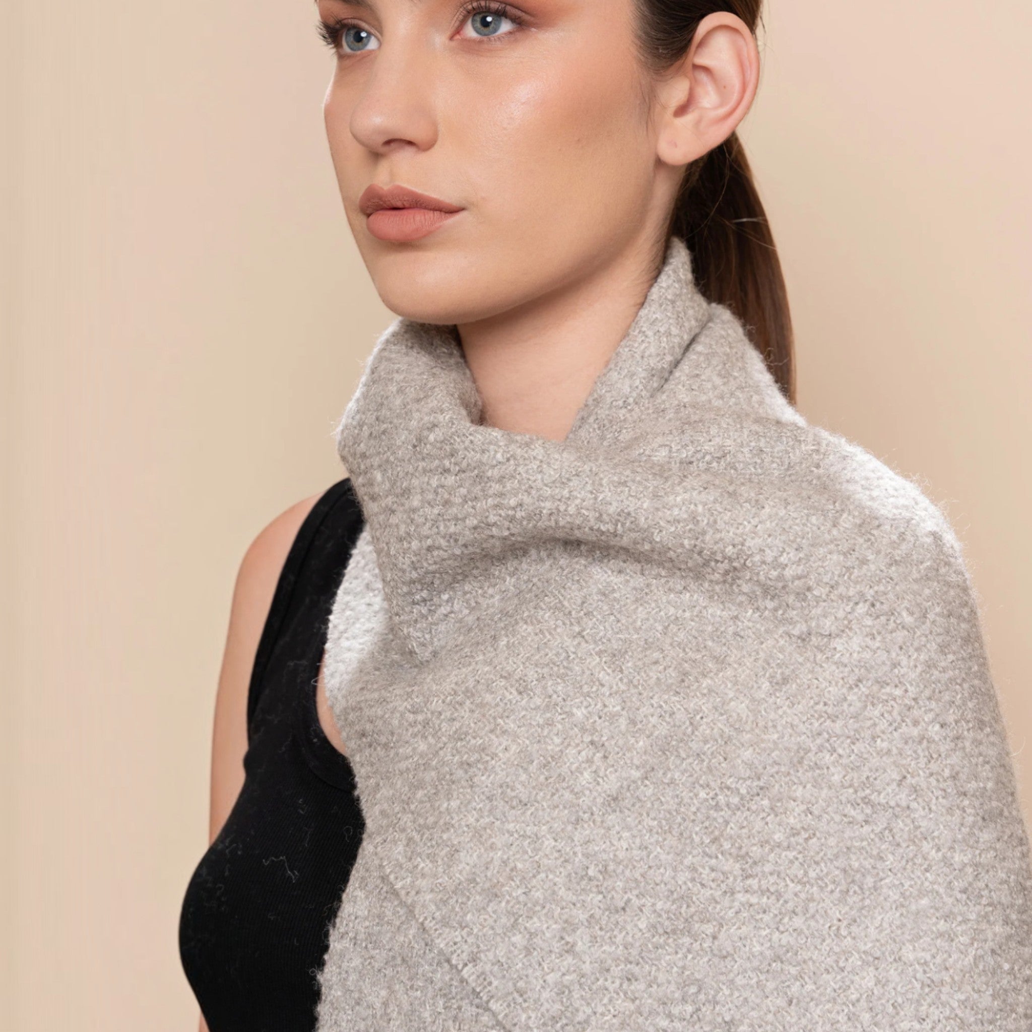 Soft mid grey undyed bouclé scarf with textured finish and twisted fringed ends