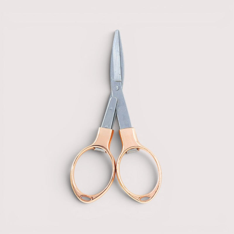 KnitPro folding scissors in gold finish, compact tool for knitting projects.