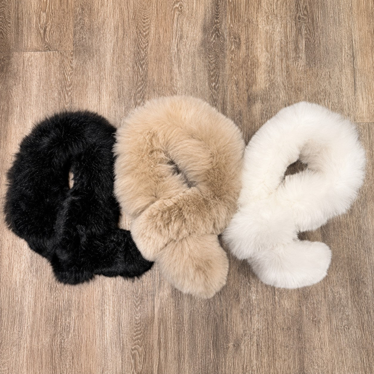 Black, taupe and white baby alpaca fur pull-through scarves displayed together