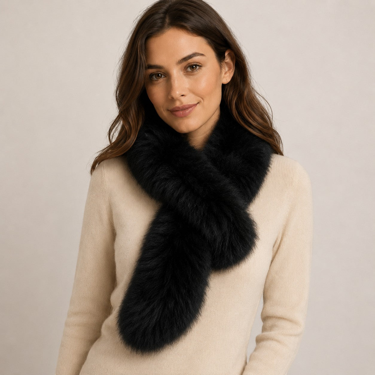 Black baby alpaca fur pull-through scarf worn by a woman in a neutral studio setting