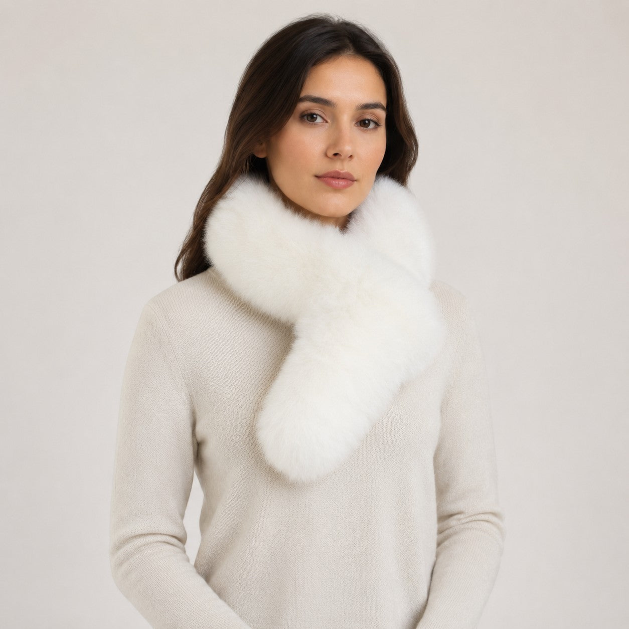 White baby alpaca fur pull-through scarf worn over a cream sweater