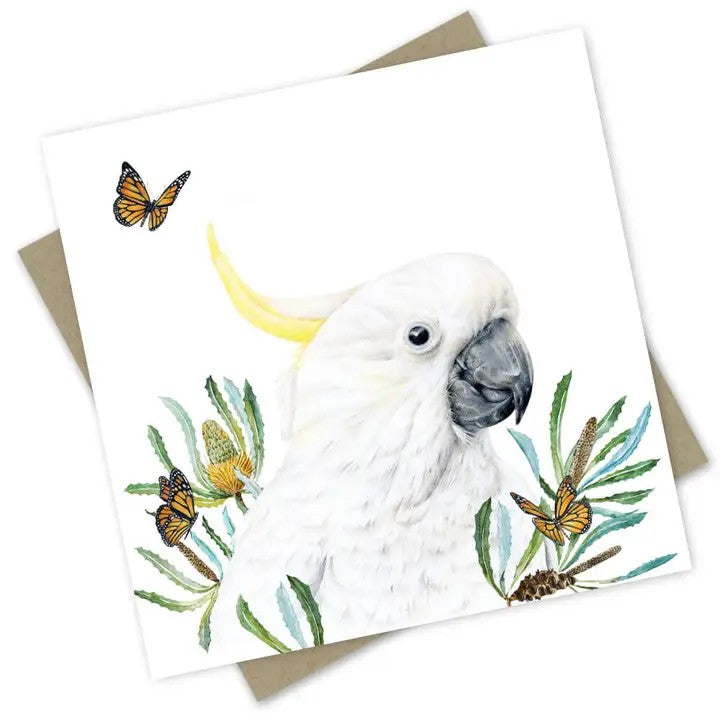Australian greeting card featuring a white sulphur-crested cockatoo surrounded by native banksias and monarch butterflies.