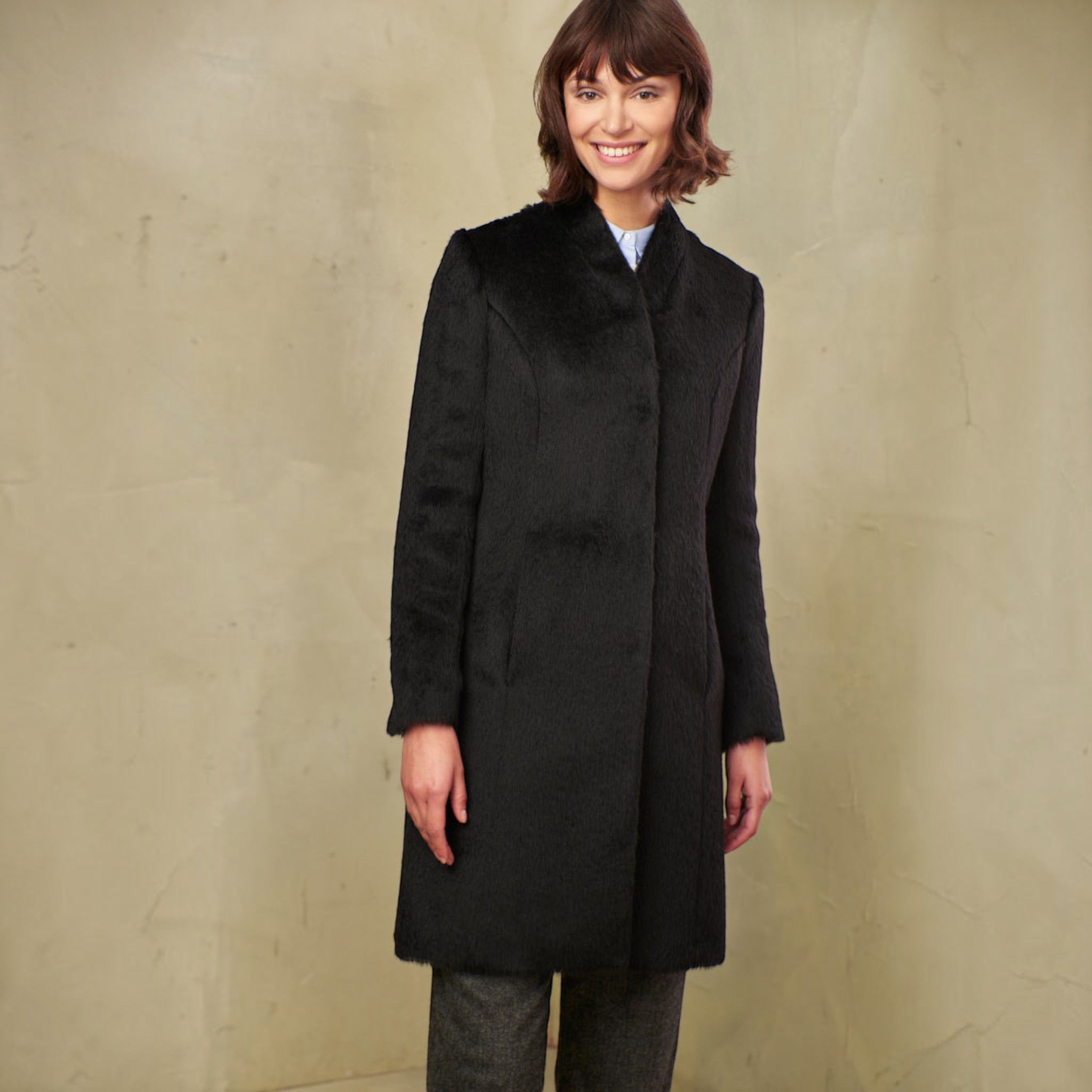 Side view of women’s black Suri alpaca and wool winter coat