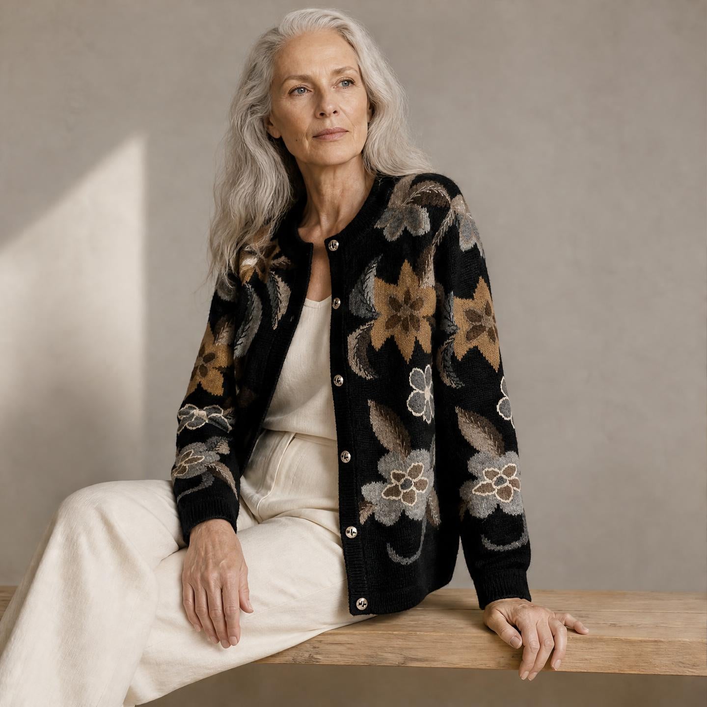 Model wearing Juliet hand knitted black alpaca cardigan with neutral floral pattern