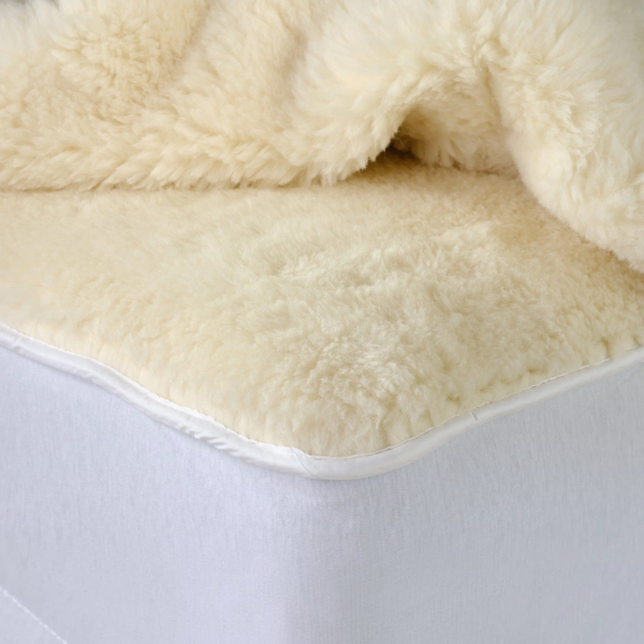 Close-up of a fluffy alpaca beige blanket on a white background