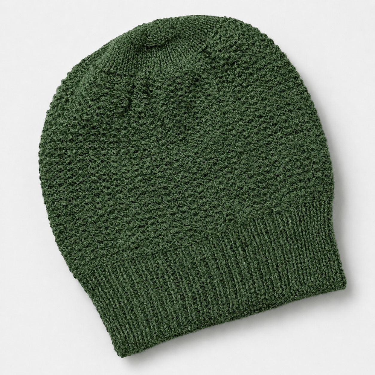 Green knit beanie made from alpaca, cosy winter accessory.