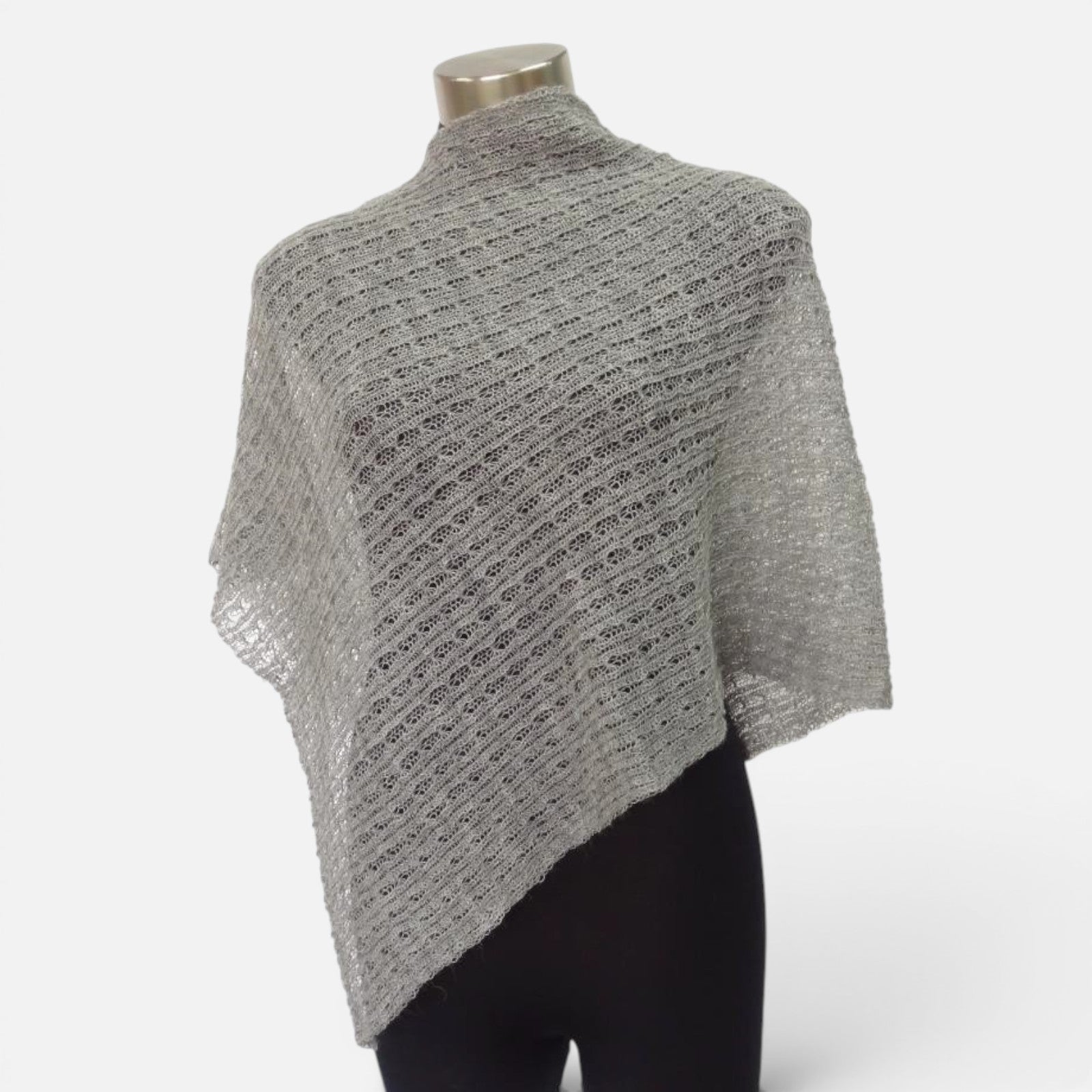 Grey lacy alpaca poncho with lightweight open-knit design displayed on a mannequin