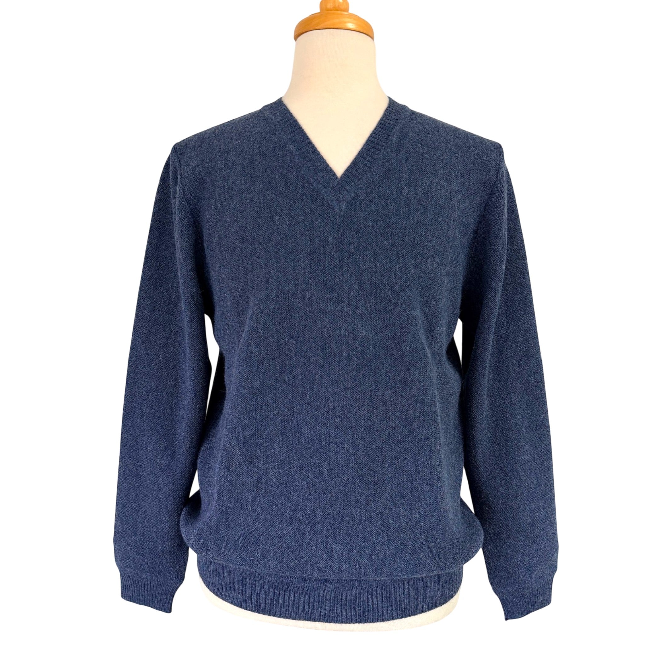 A navy blue Alpaca V-neck knit sweater displayed on a mannequin torso against a plain white background.
