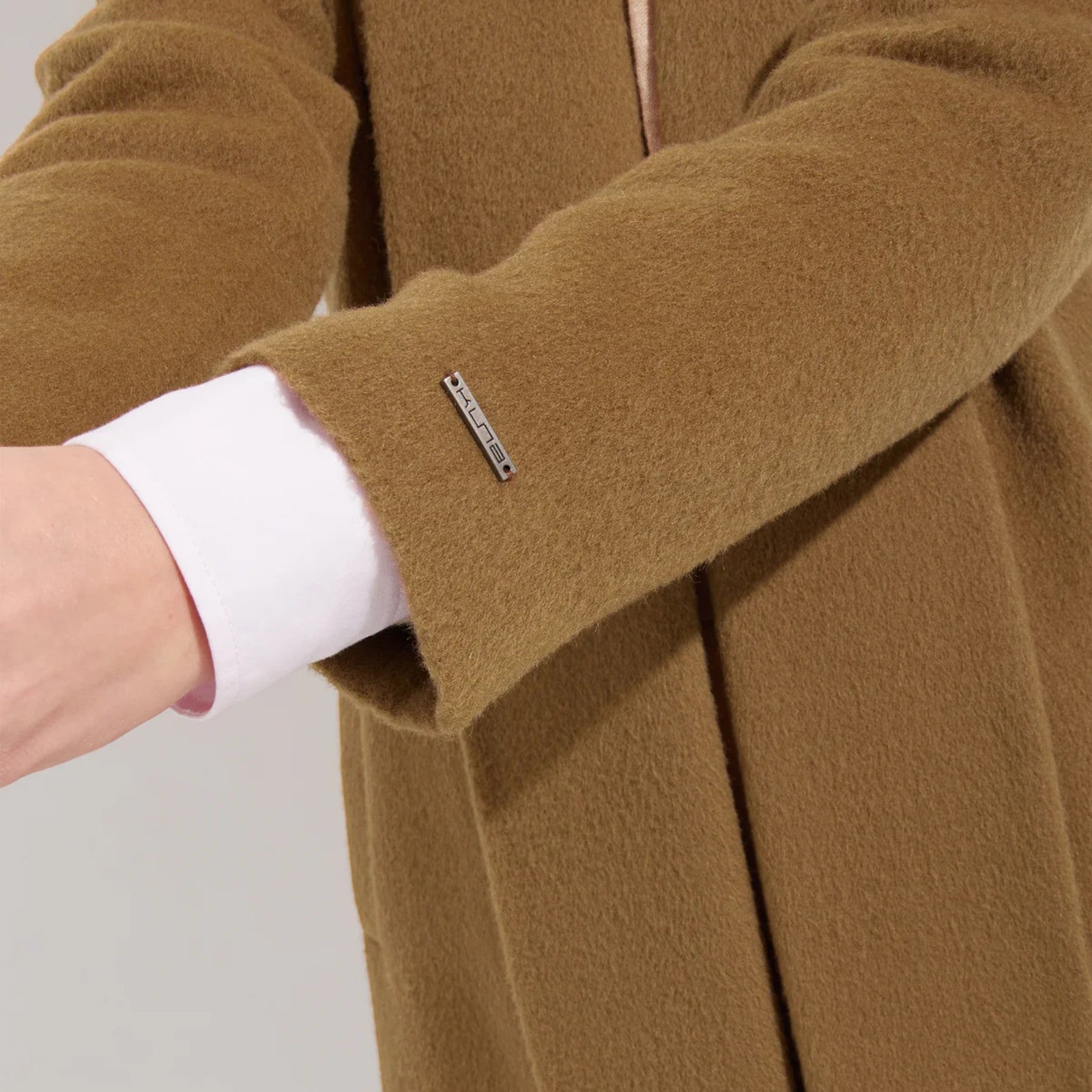 Close-up of Women’s long camel alpaca coat for sophisticated winter layering