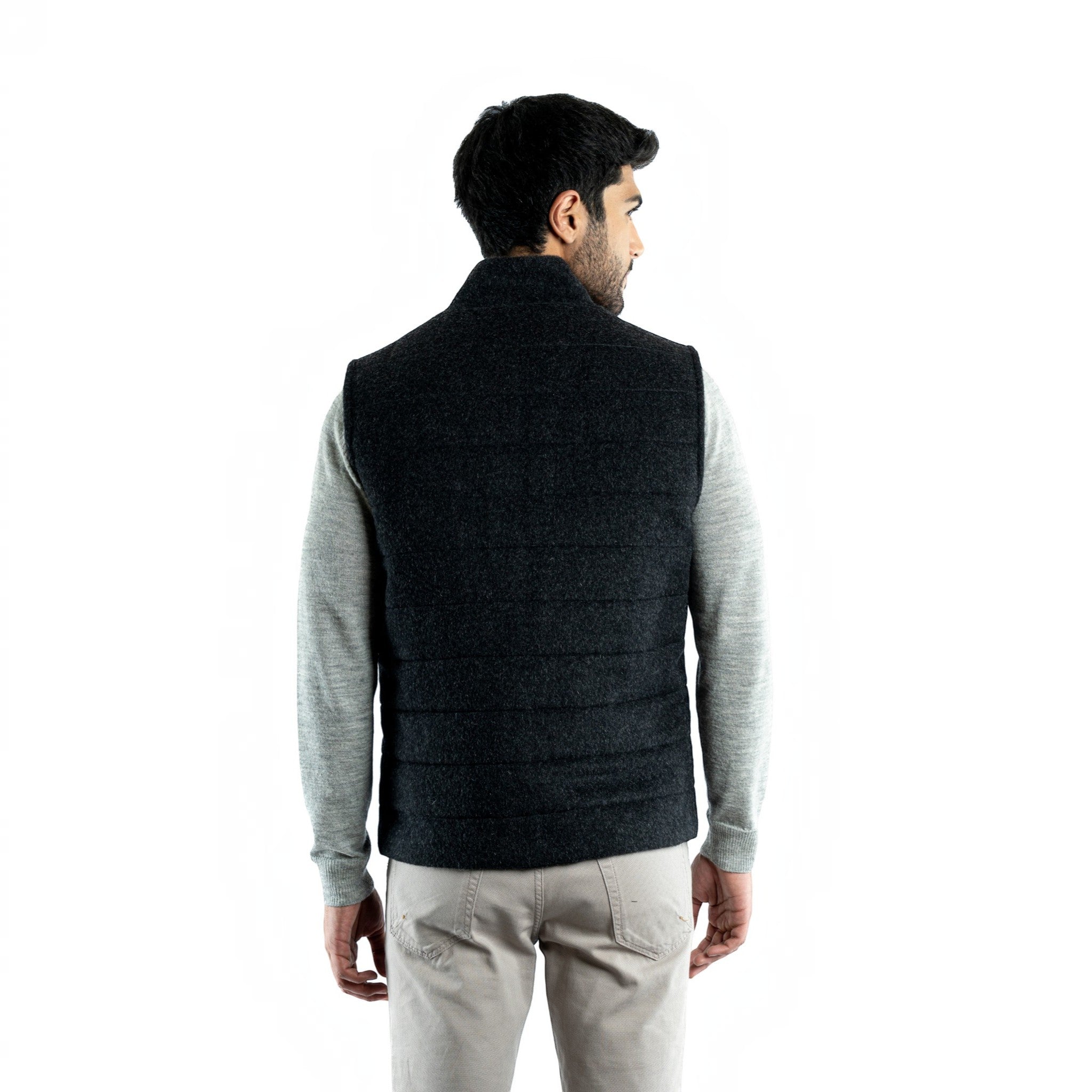 Back view of the men’s charcoal quilted alpaca vest showing the tailored fit