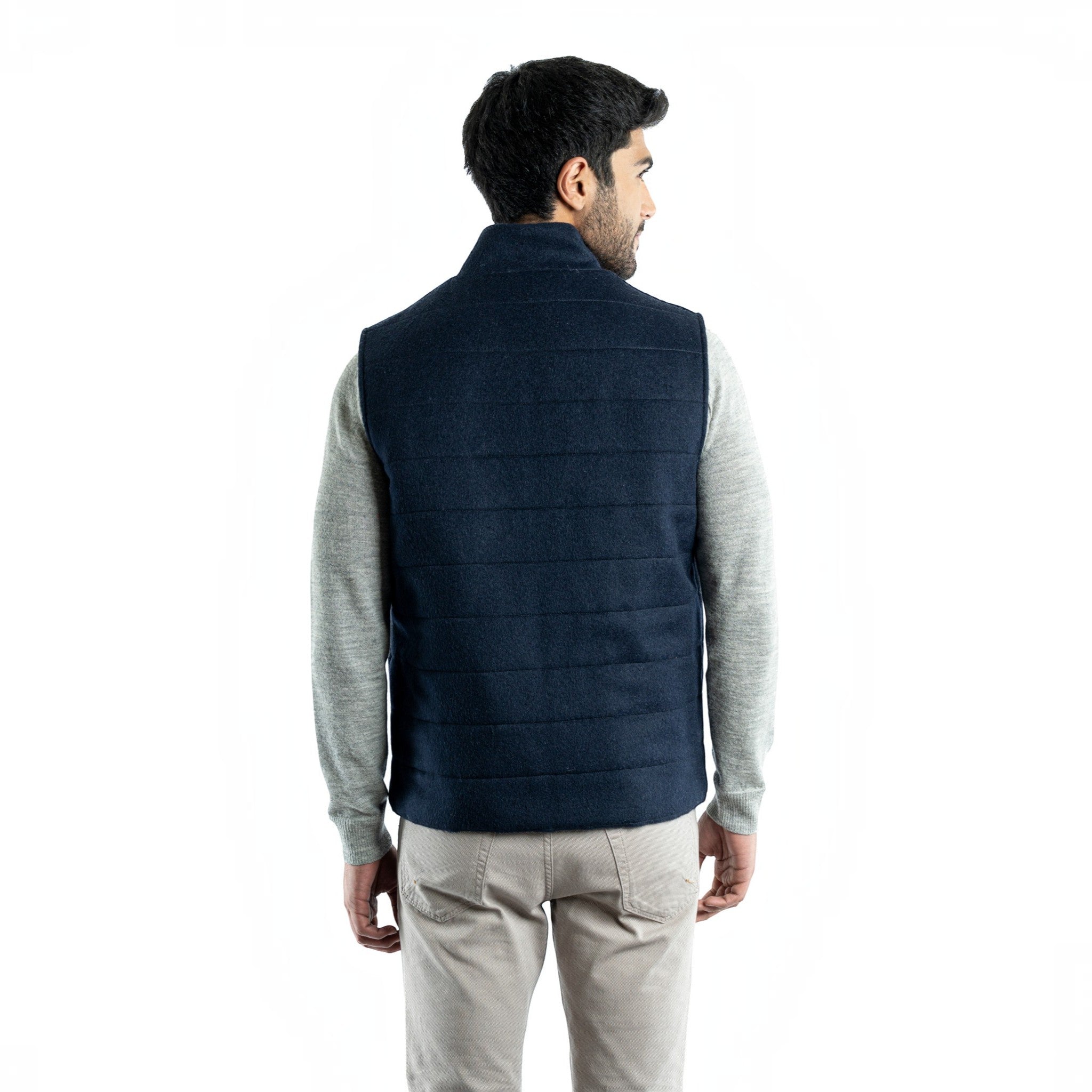Back view of the men’s navy quilted alpaca vest with horizontal channel stitching