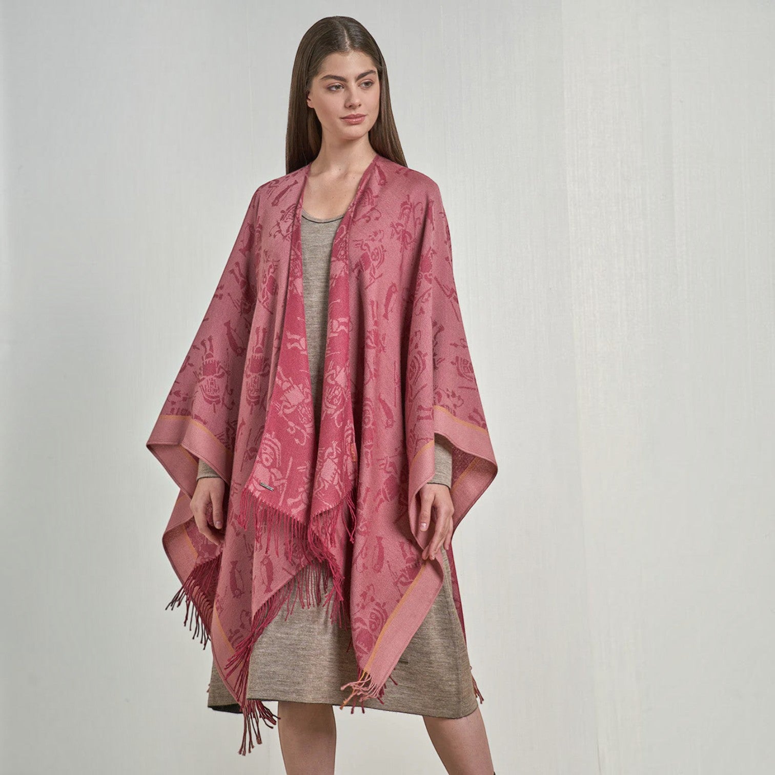 Close-up of the soft pink and fuchsia woven motif on the royal alpaca cape