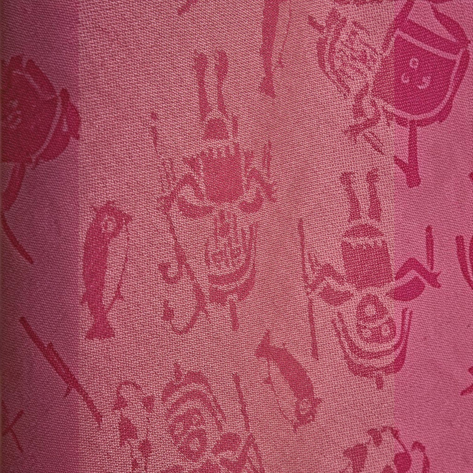 Close-up of the soft pink and fuchsia woven motif on the royal alpaca cape