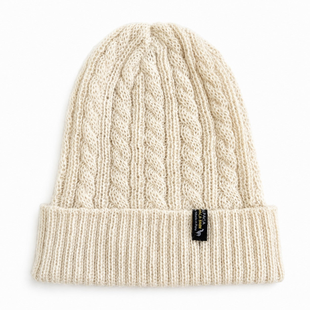 Warm breathable alpaca beanie with cable knit pattern in cream