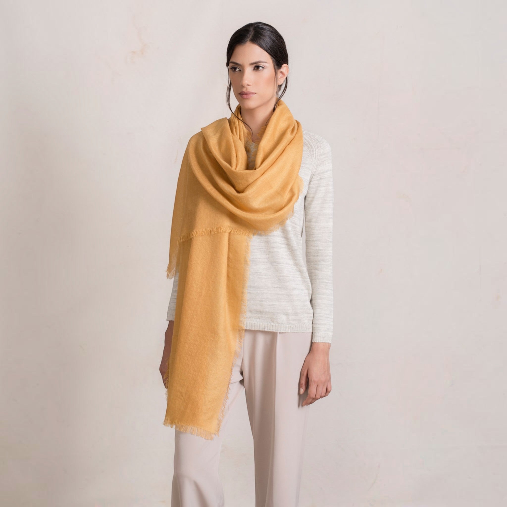 Model wearing gold alpaca silk shawl, lightweight warm natural fibre accessory.