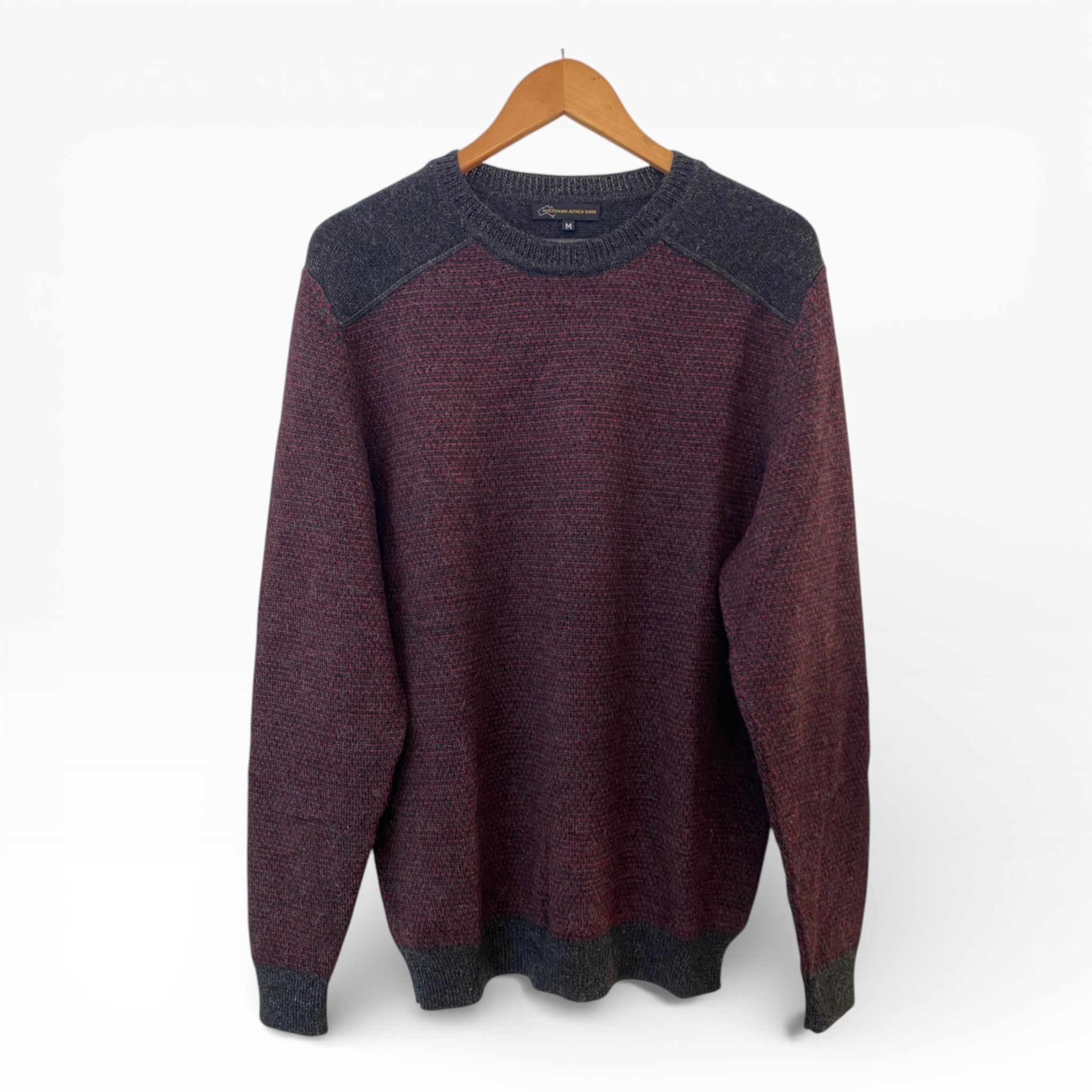 Charcoal/Cherry Sweater with Charcoal collar and cuffs on a wooden hanger against a white background