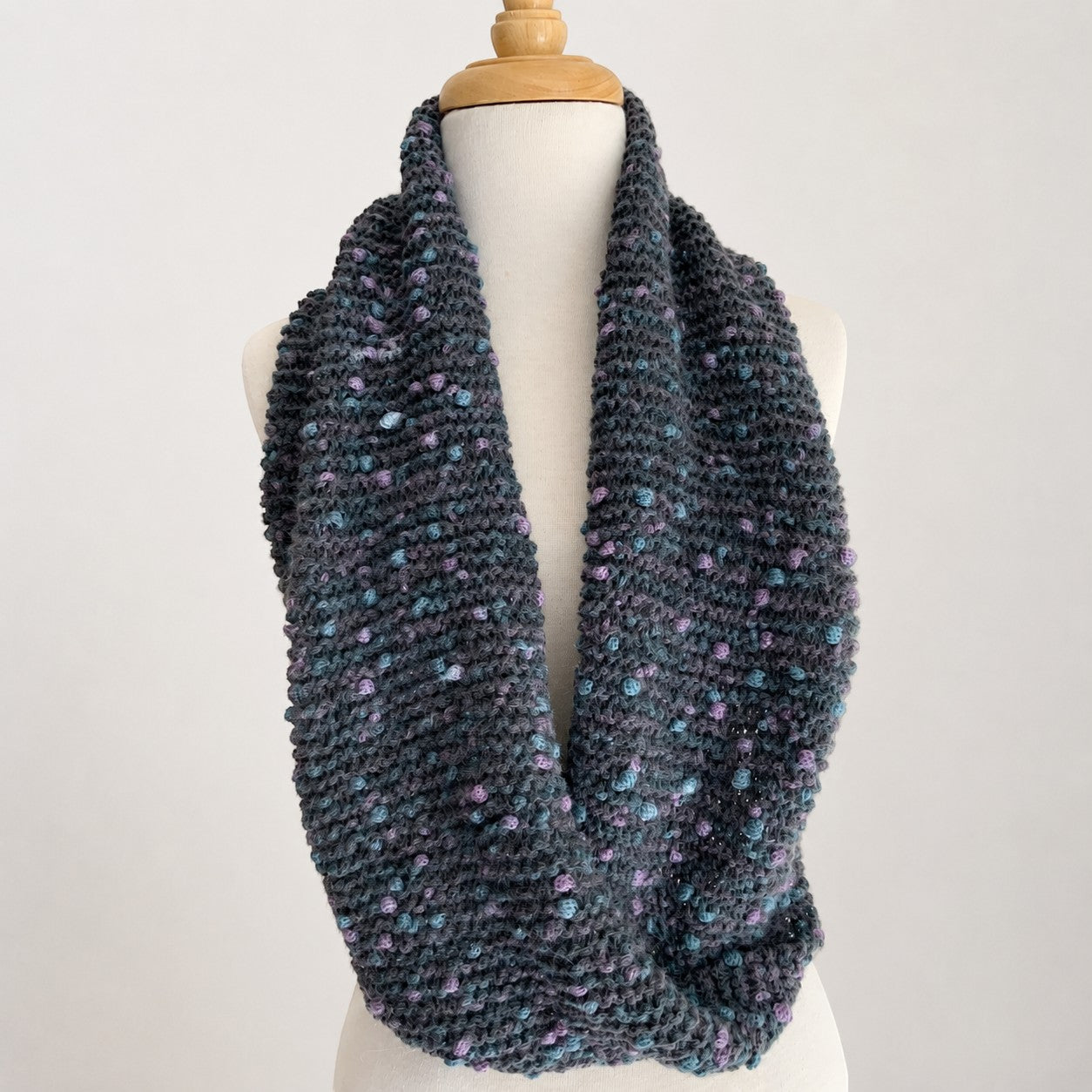Textured grey alpaca infinity scarf displayed on a mannequin