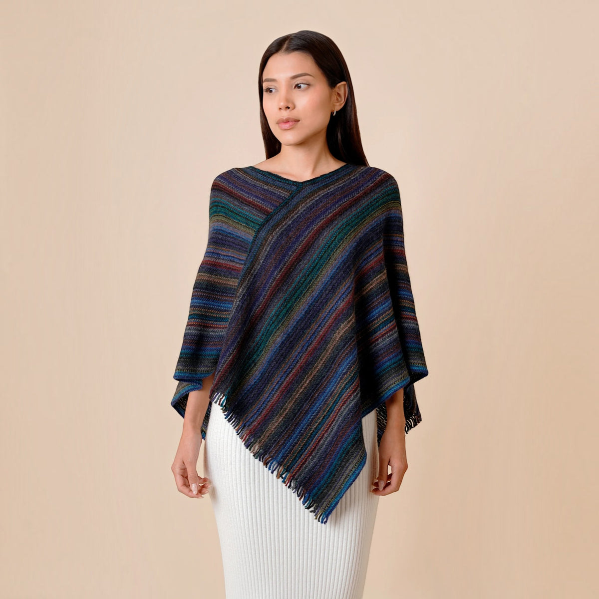 Dark multicoloured striped alpaca poncho with asymmetric drape and fringe detail