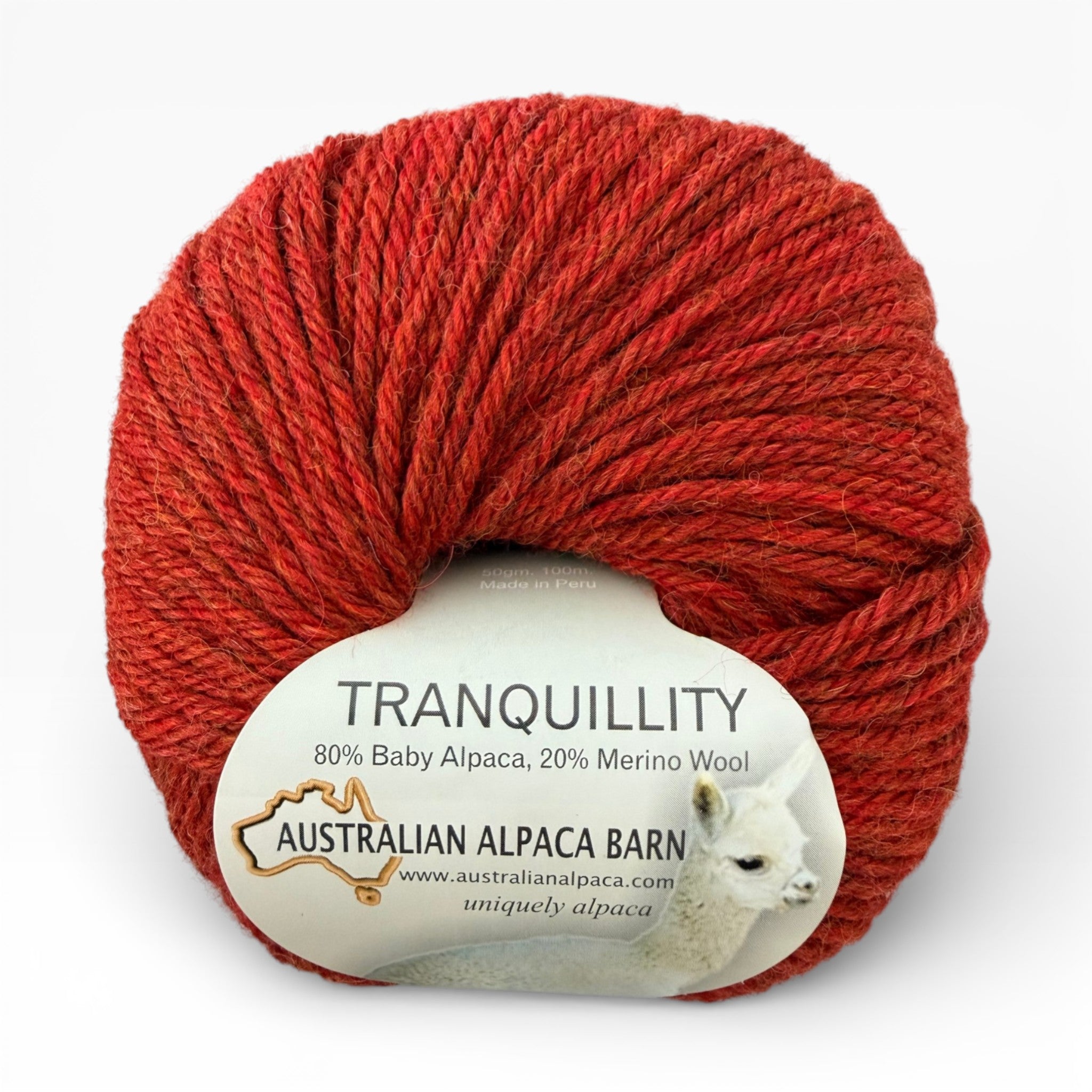 Red melange alpaca yarn ball with 'Tranquillity' label on a white background