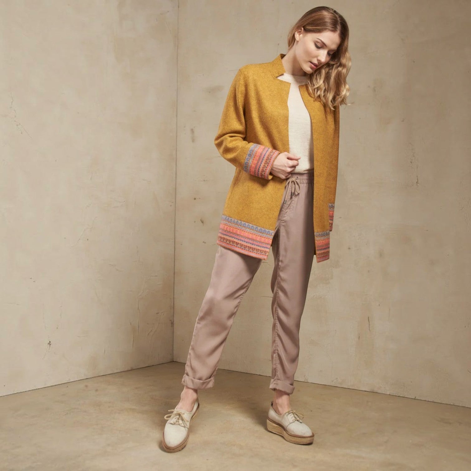 Full-length view of the Sangria mustard alpaca coat with open front and patterned cuffs