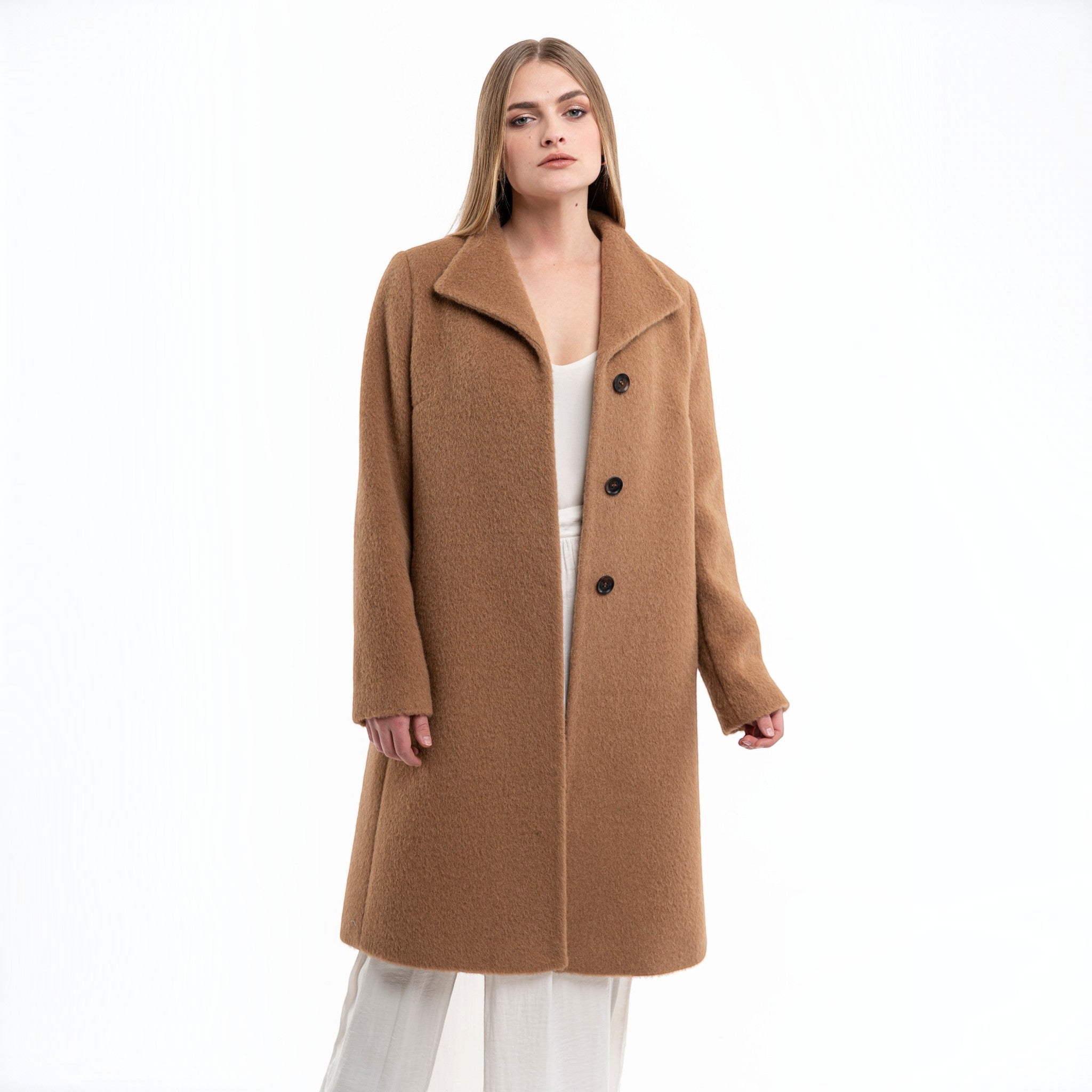 Woman wearing the Short Classic Coat in Cinnamon with cream trousers