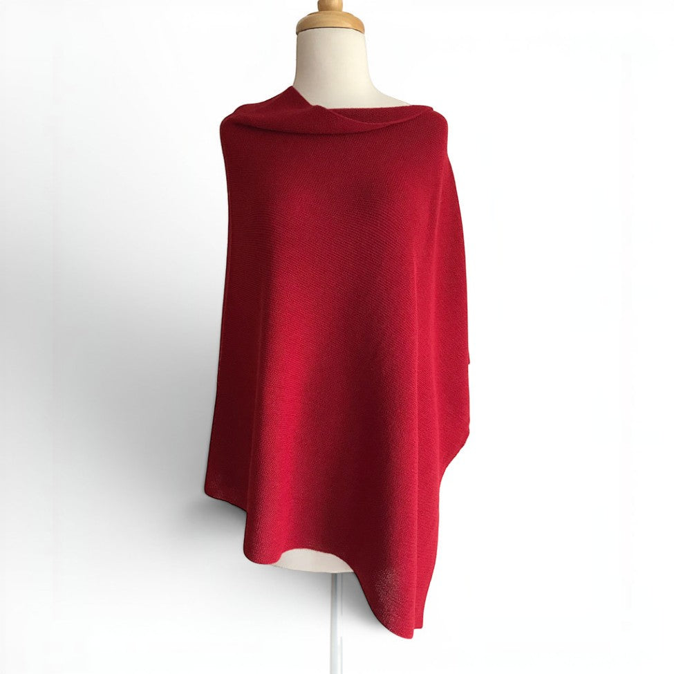 Women’s red Sorpresa alpaca poncho with a bateau neckline and asymmetric hem