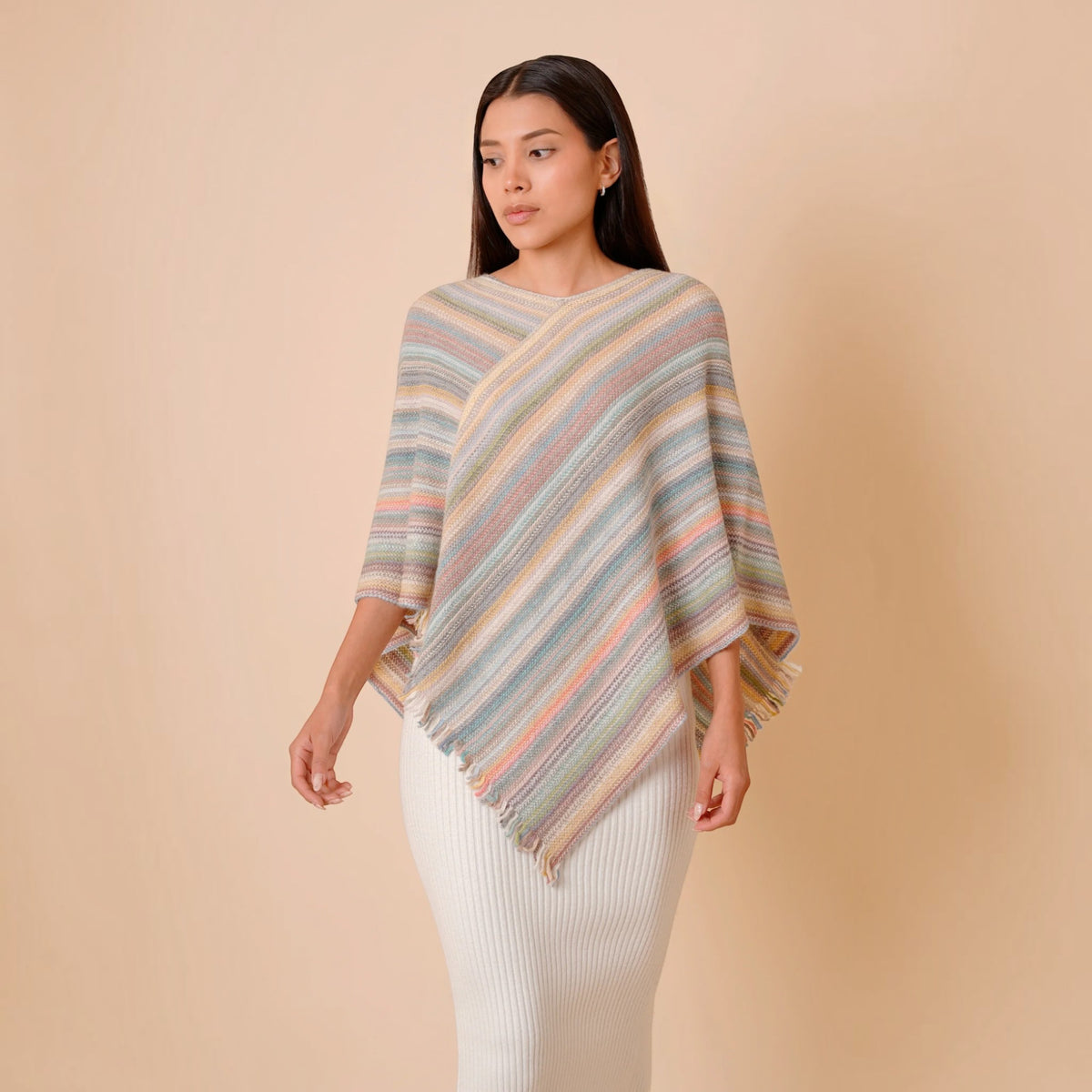 One size striped alpaca blend poncho with diagonal knit design and asymmetric hem