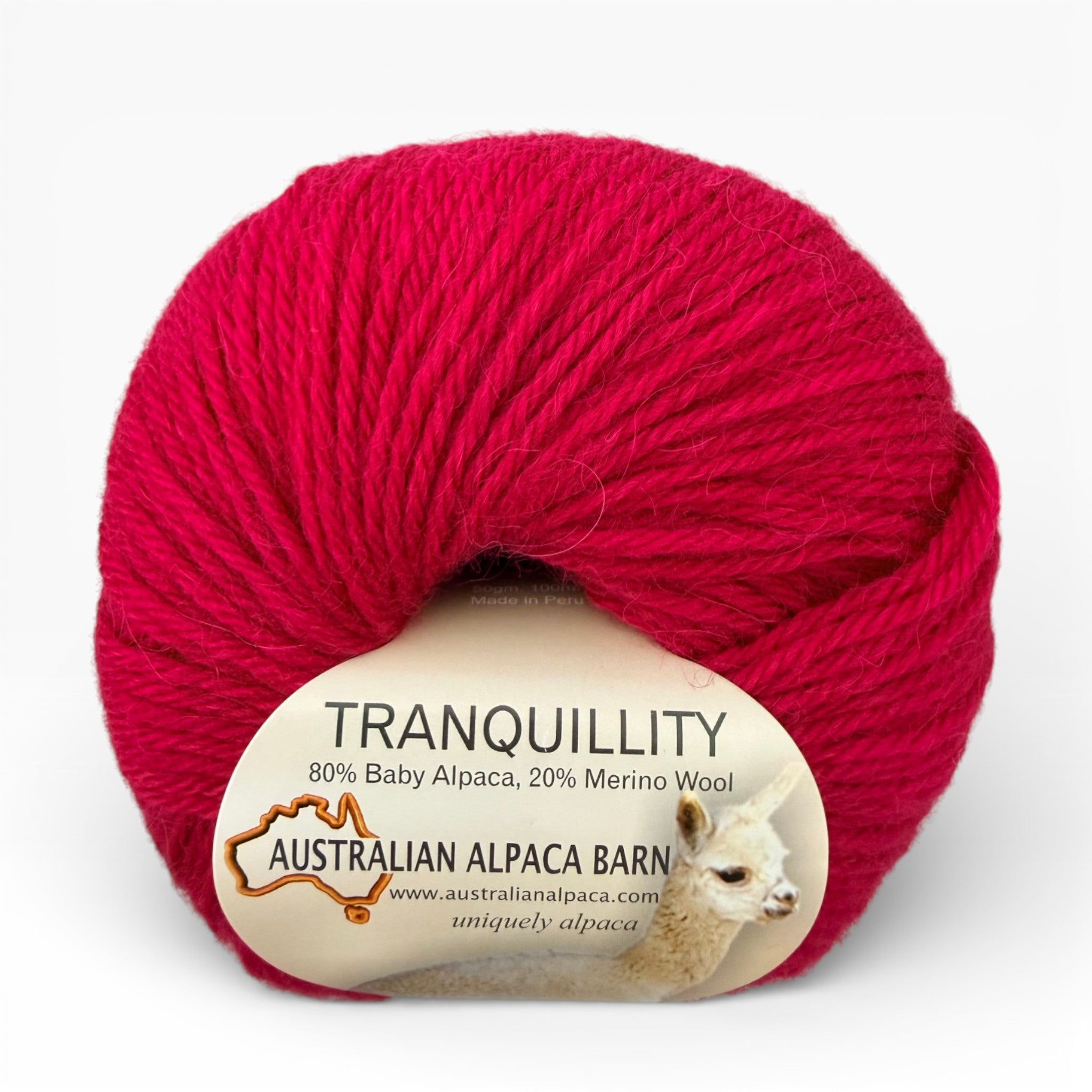Pink Alpaca yarn ball with a label on a white background