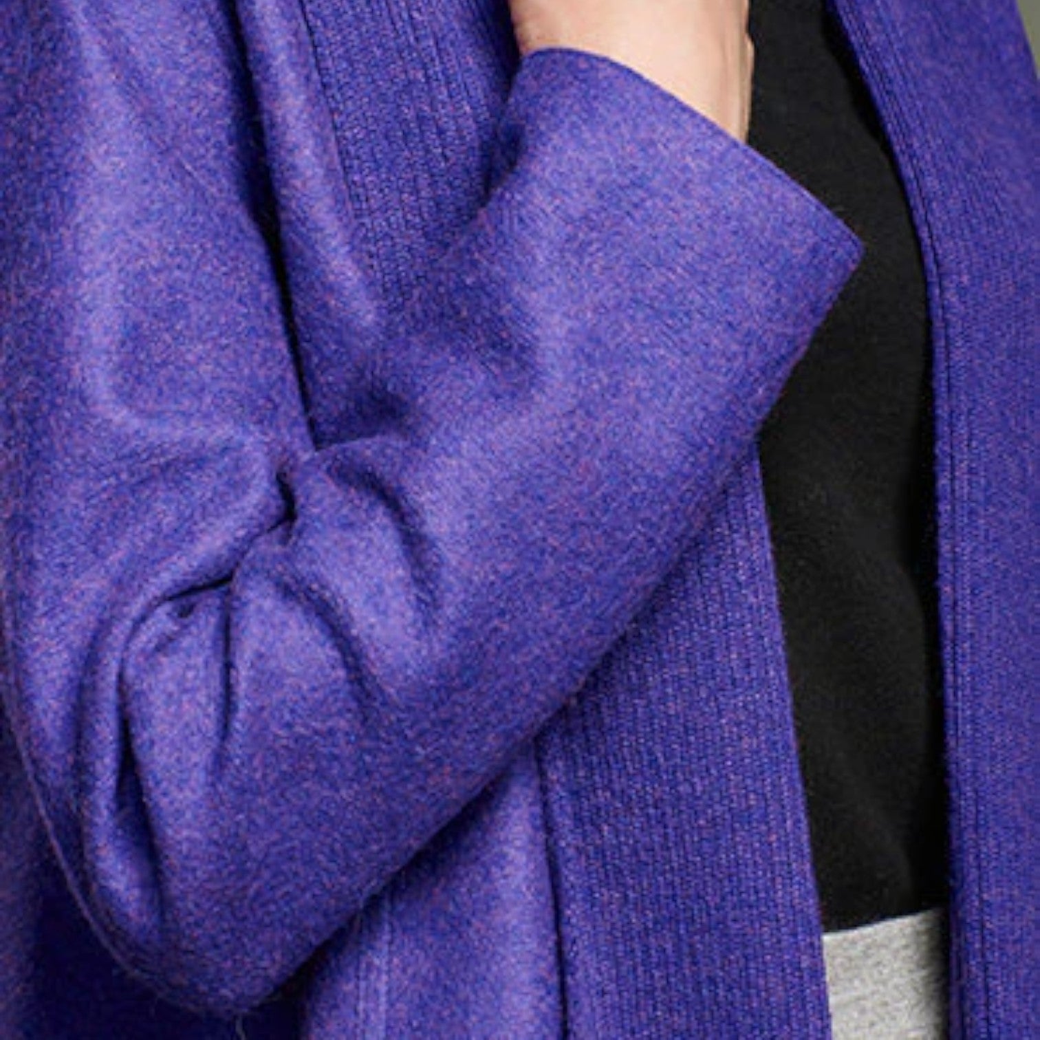 Close-up of the Tamesis coat showing the purple alpaca wool texture and knitted collar