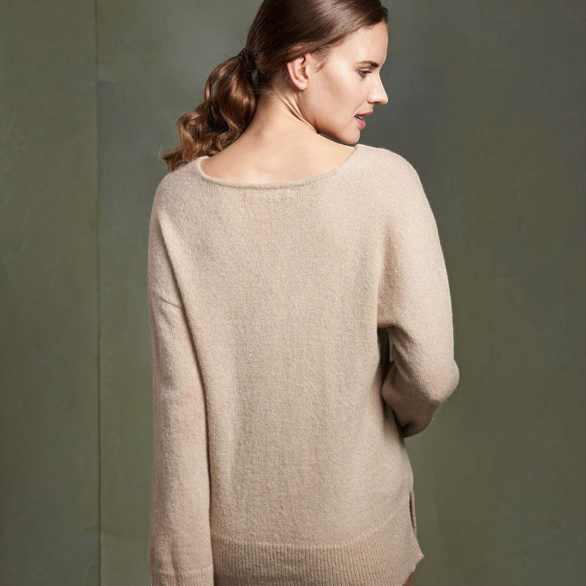 Model wearing Tammy alpaca sweater in Nomad colour