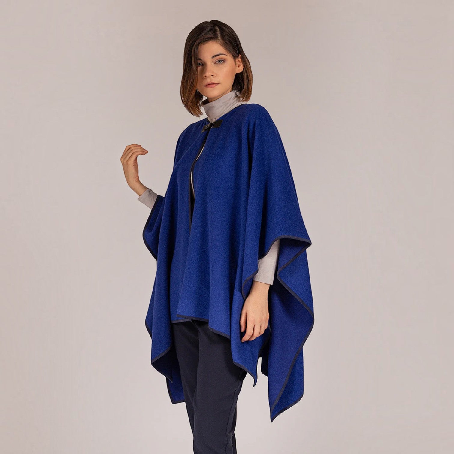 Women’s Cadet blue baby alpaca cape styled over a roll-neck top