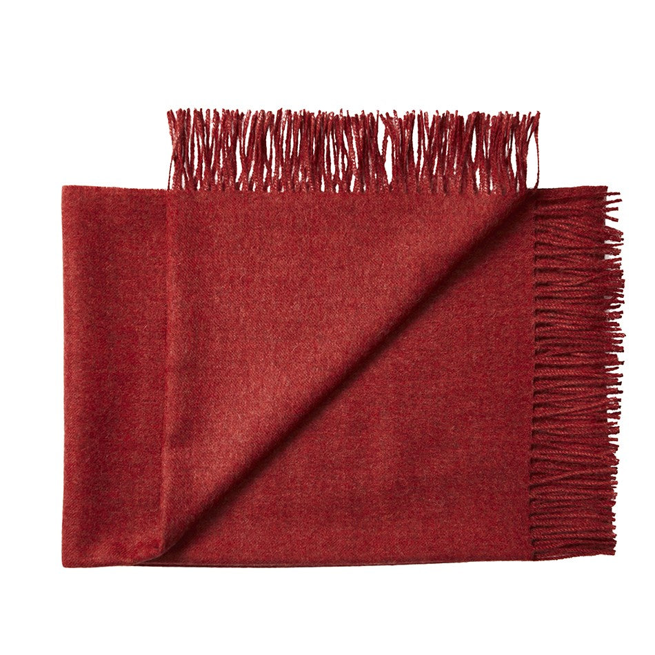 100% baby alpaca throw rug as a luxury winter gift in ruby with fringe