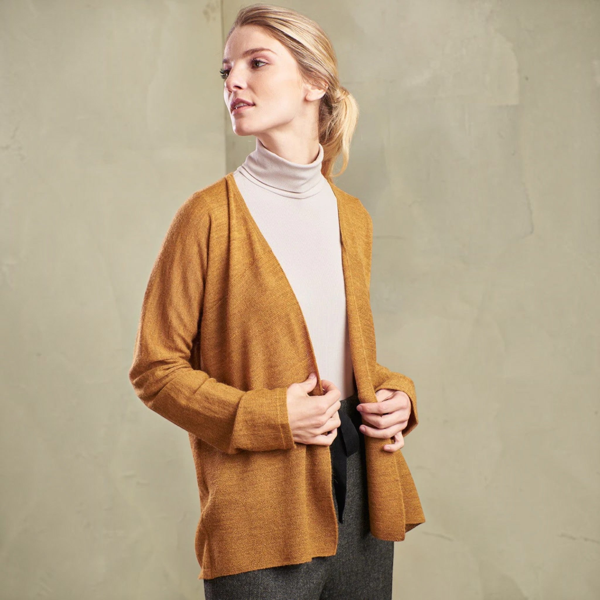 Female model wearing KUNA Tomorrow cardigan in refined alpaca knit