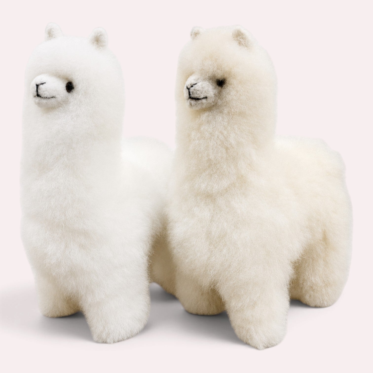 Two fluffy white alpaca baby Alpaca fur toys standing side by side.