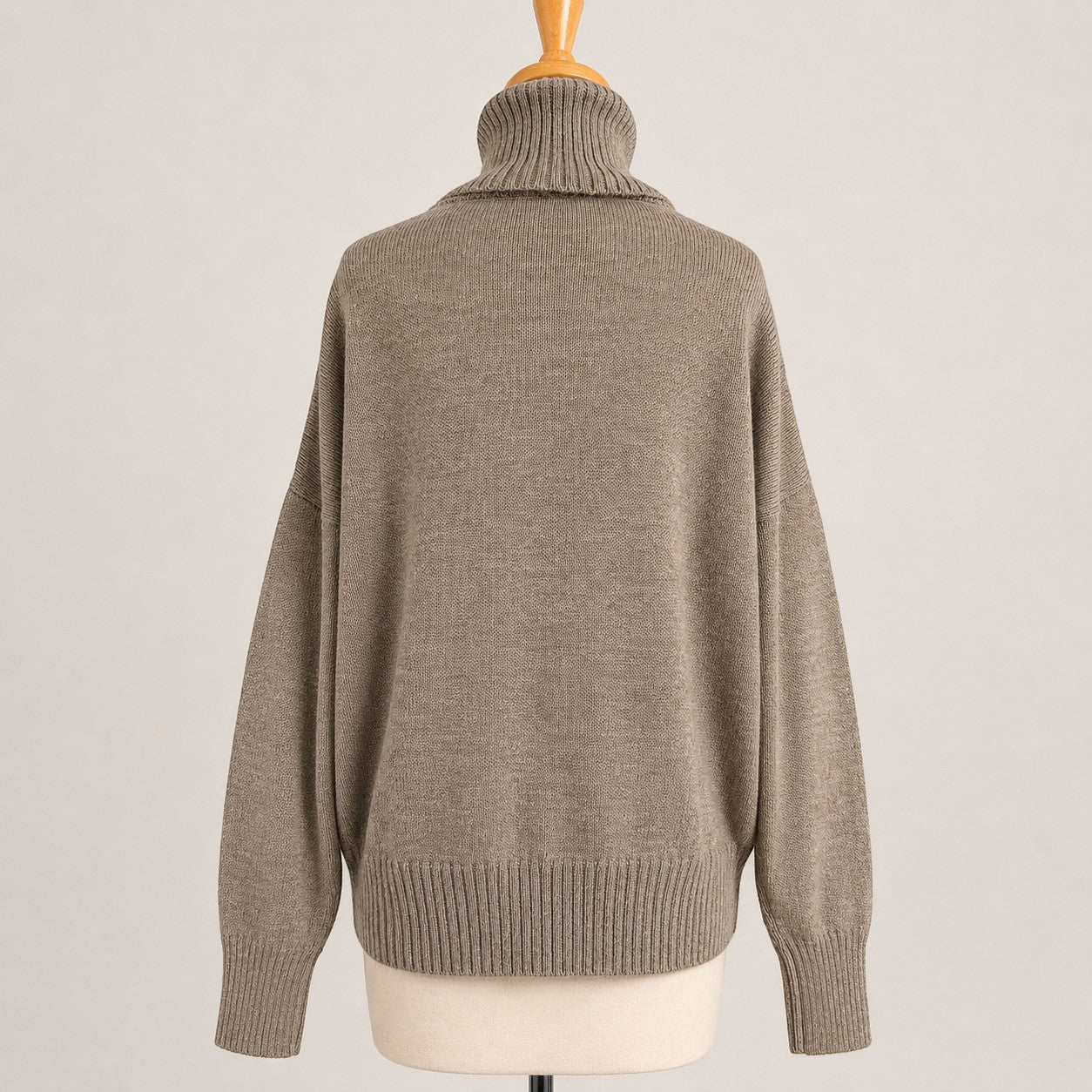 Women’s alpaca turtleneck jumper in natural beige, cosy cold weather layer.