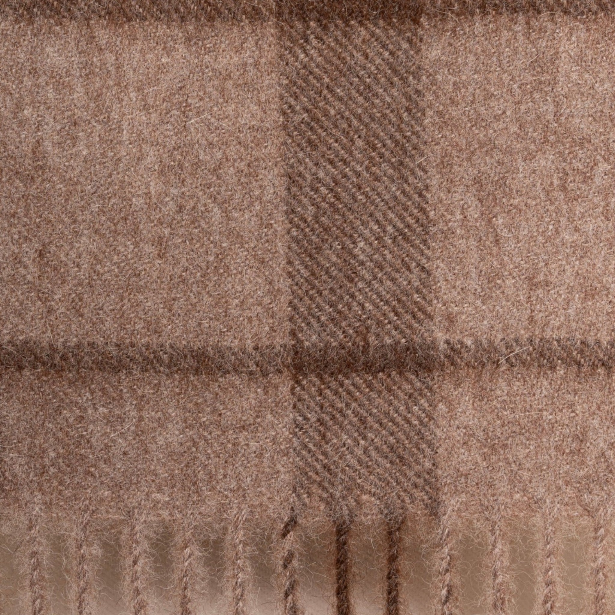 Close Up of Undyed taupe and brown alpaca scarf with classic check pattern and elegant fringed finish