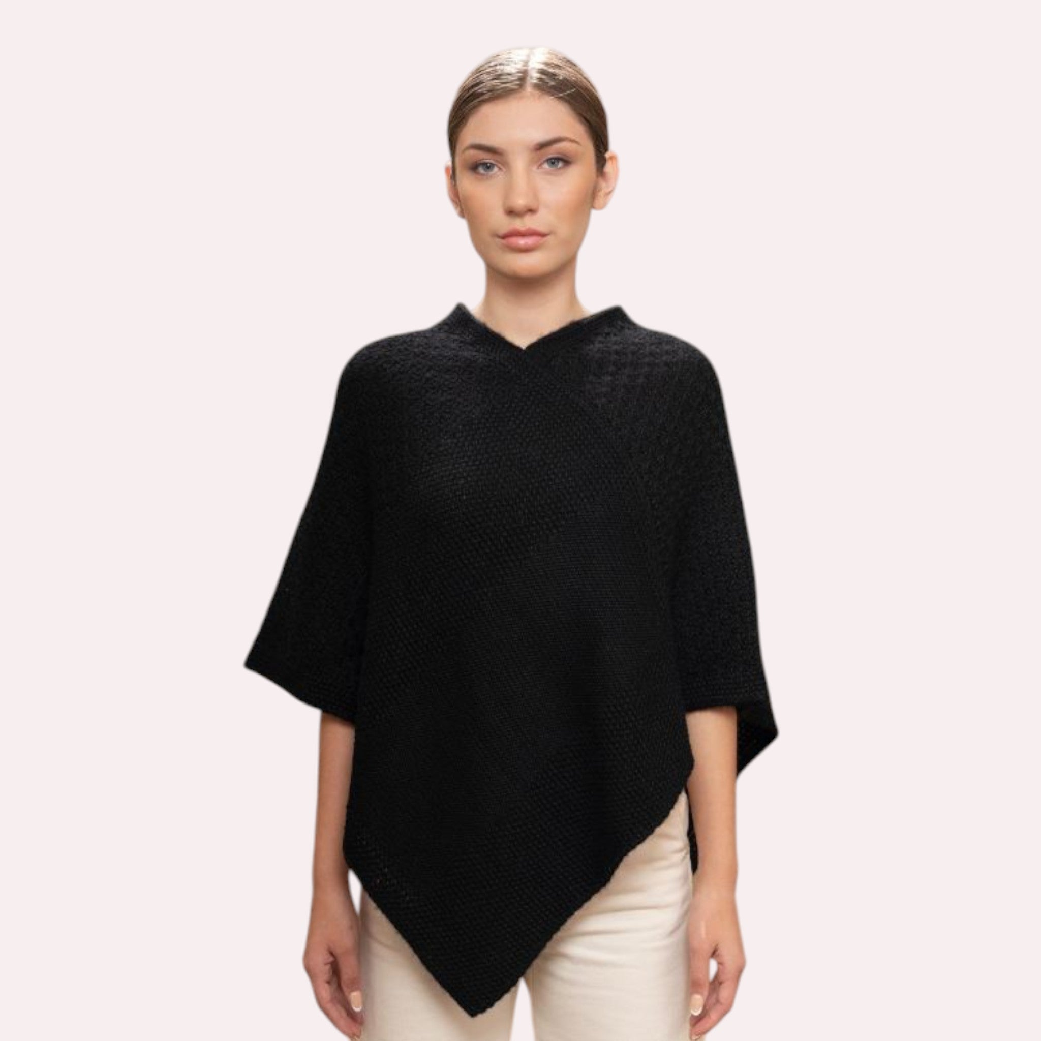 Women’s knitted alpaca poncho in Black, cosy cold weather layers.