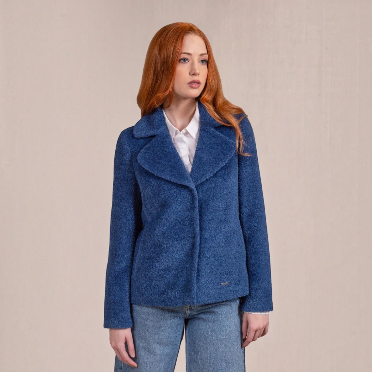 Woman wearing blue Velours Suri alpaca jacket with butterfly collar