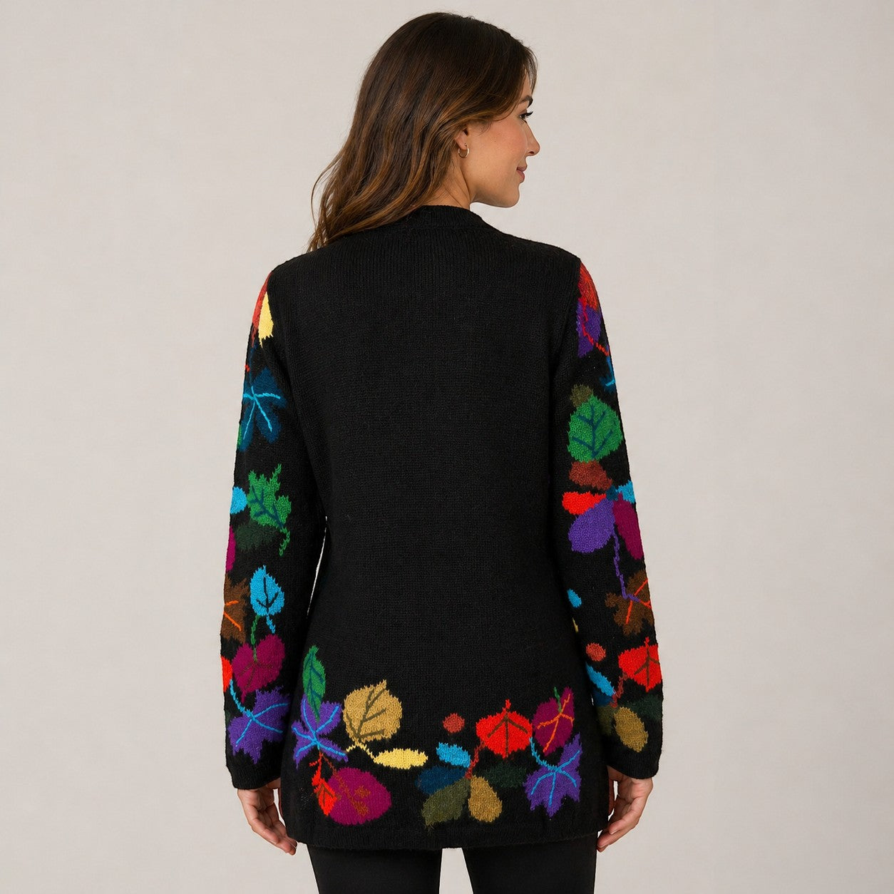 Woman wearing soft winter cardigan with multicolour intarsia design